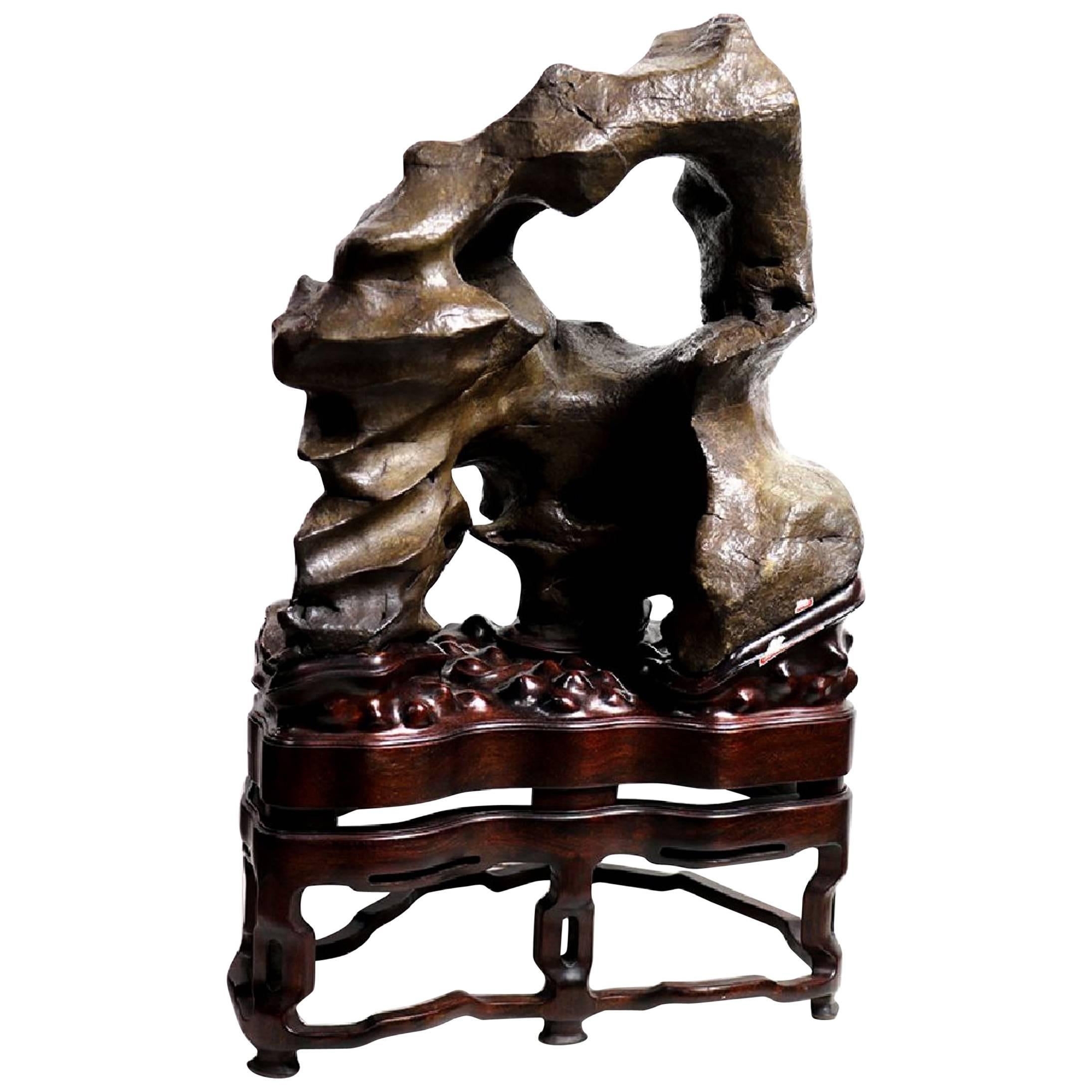 On offer is an extraordinary and very rare Chinese Scholar Rock (also known as Gongshi, the meditate rock) on a custom stand, the rock is from Lingbi, one of the four famous historical scholar rock-producing towns in China. The scholar rock is