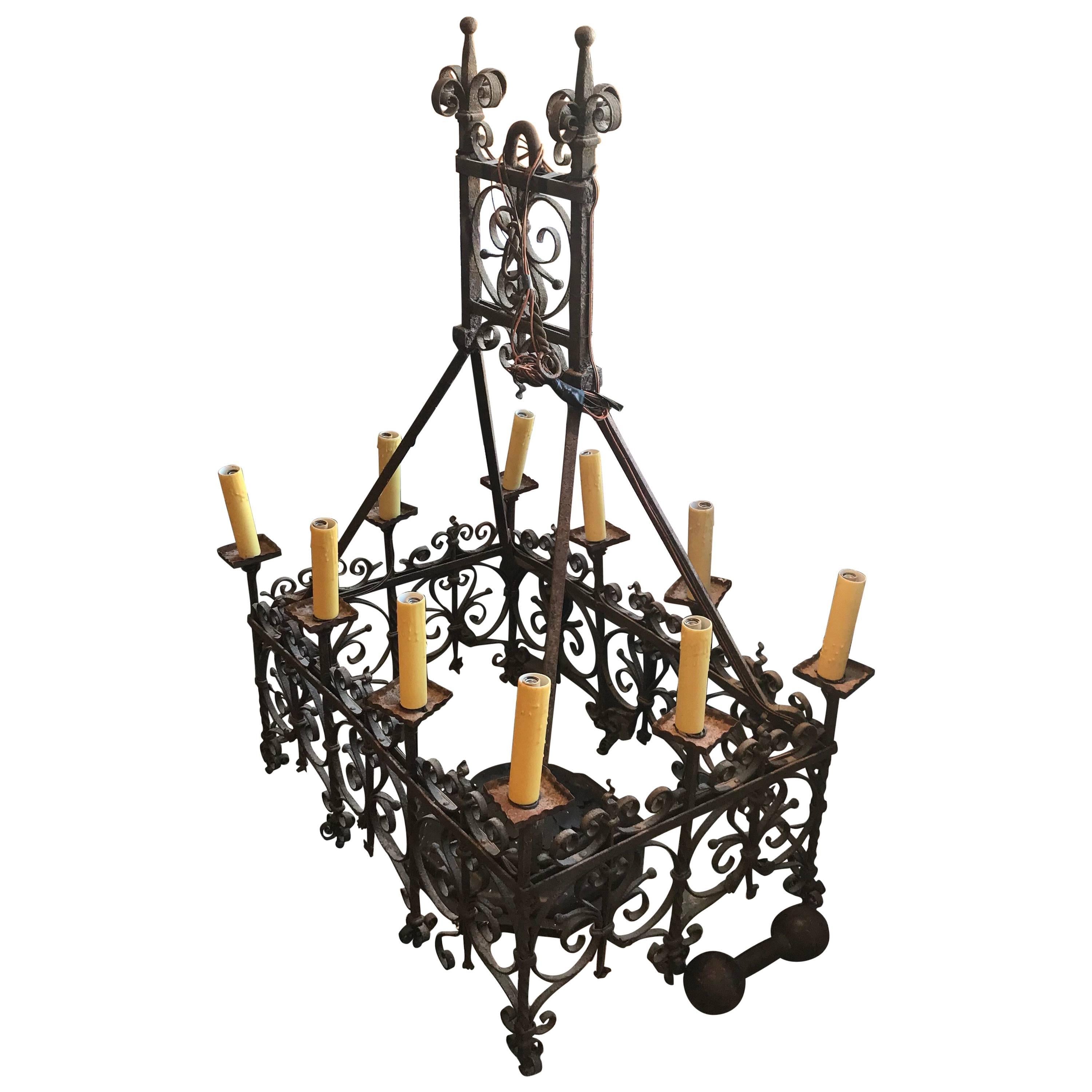 Wonderful 18th century Spanish or French wrought iron chandelier. Wonderfully hand bent wrought iron detailing. Originally was fitted for candles but has since been retrofitted to electricity. This a great example of an early european lighting