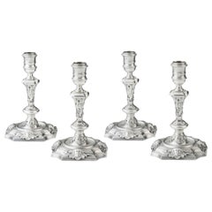 Very Rare and Unusual Set of Four George II Cast Rococo Candlesticks