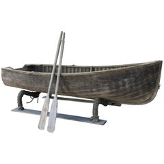 Vintage Wooden Rowboat with Two Oars