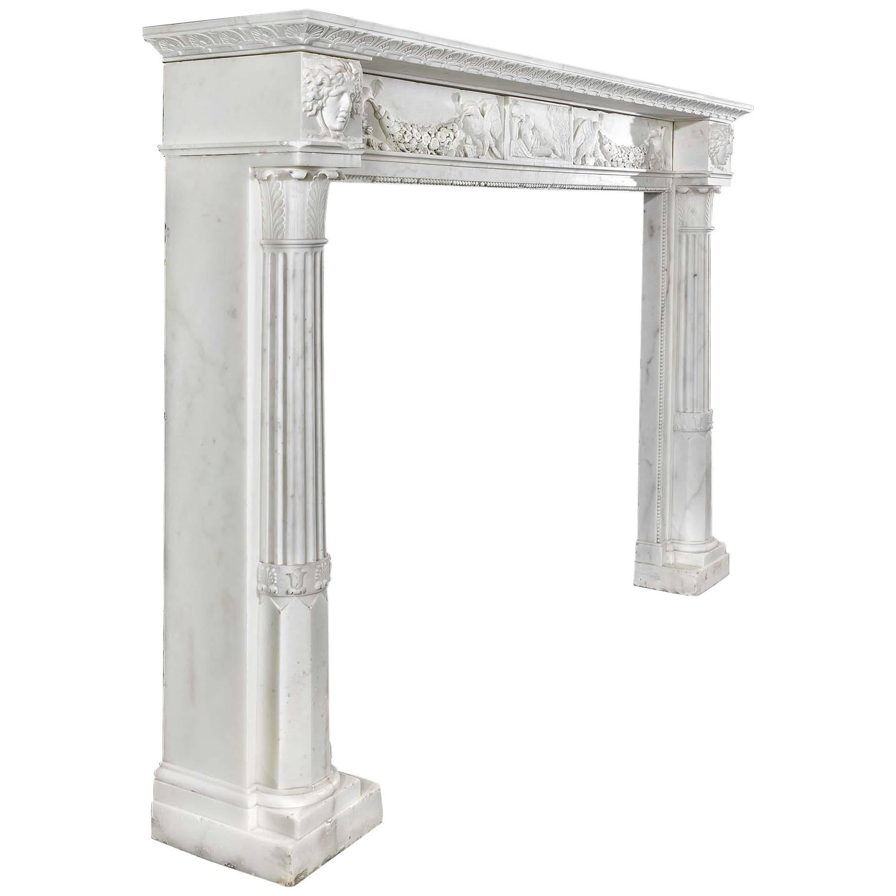 A fine and elegant Italian carrara marble antique chimneypiece with a richly embellished undershelf. The recessed frieze has a central panel carved with a reclining Venus, either side of which are two pairs of birds, each pair bearing a garland in