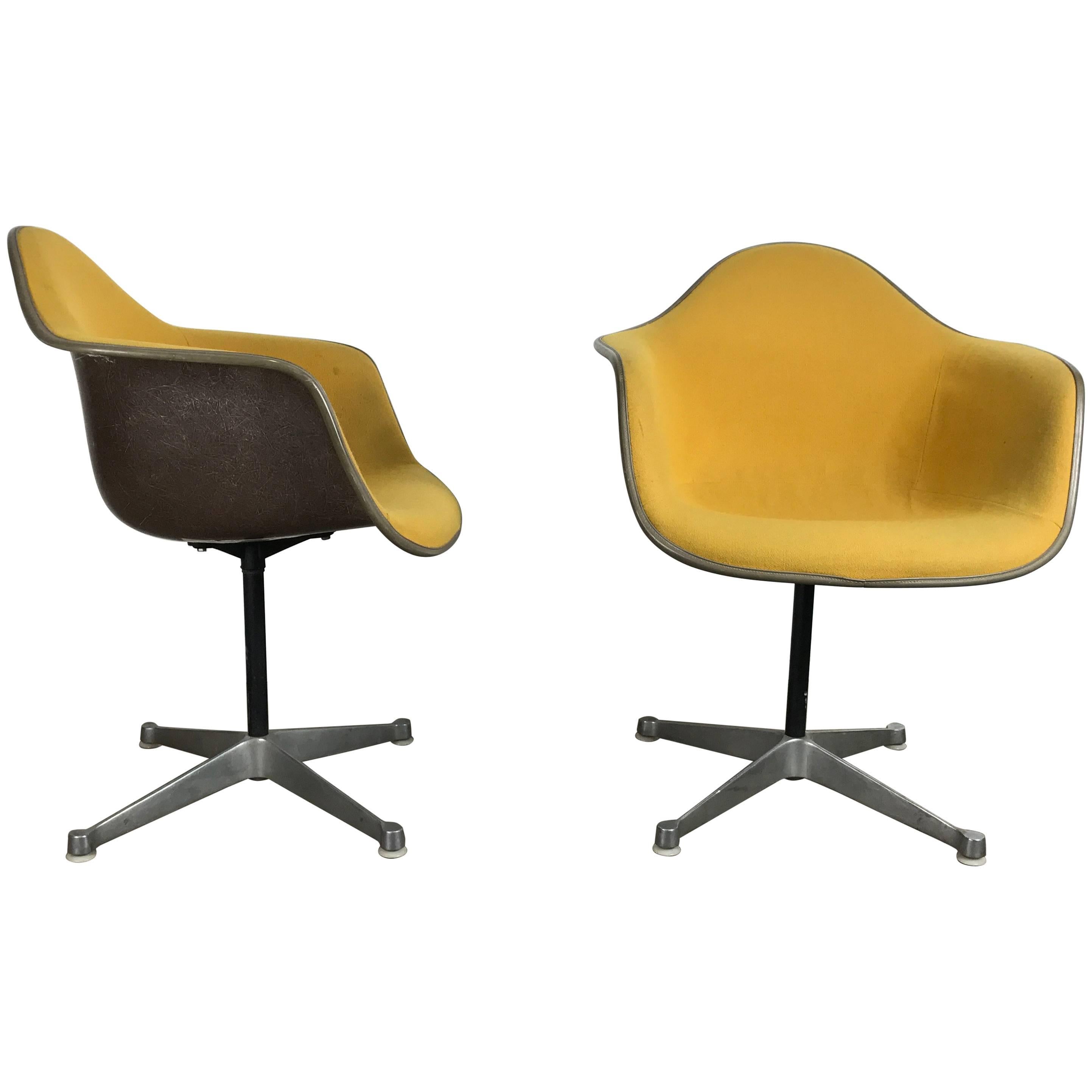 Pair of Charles and Ray Eames Swivel Padded Arm Shell Chairs, Two-Tone For Sale