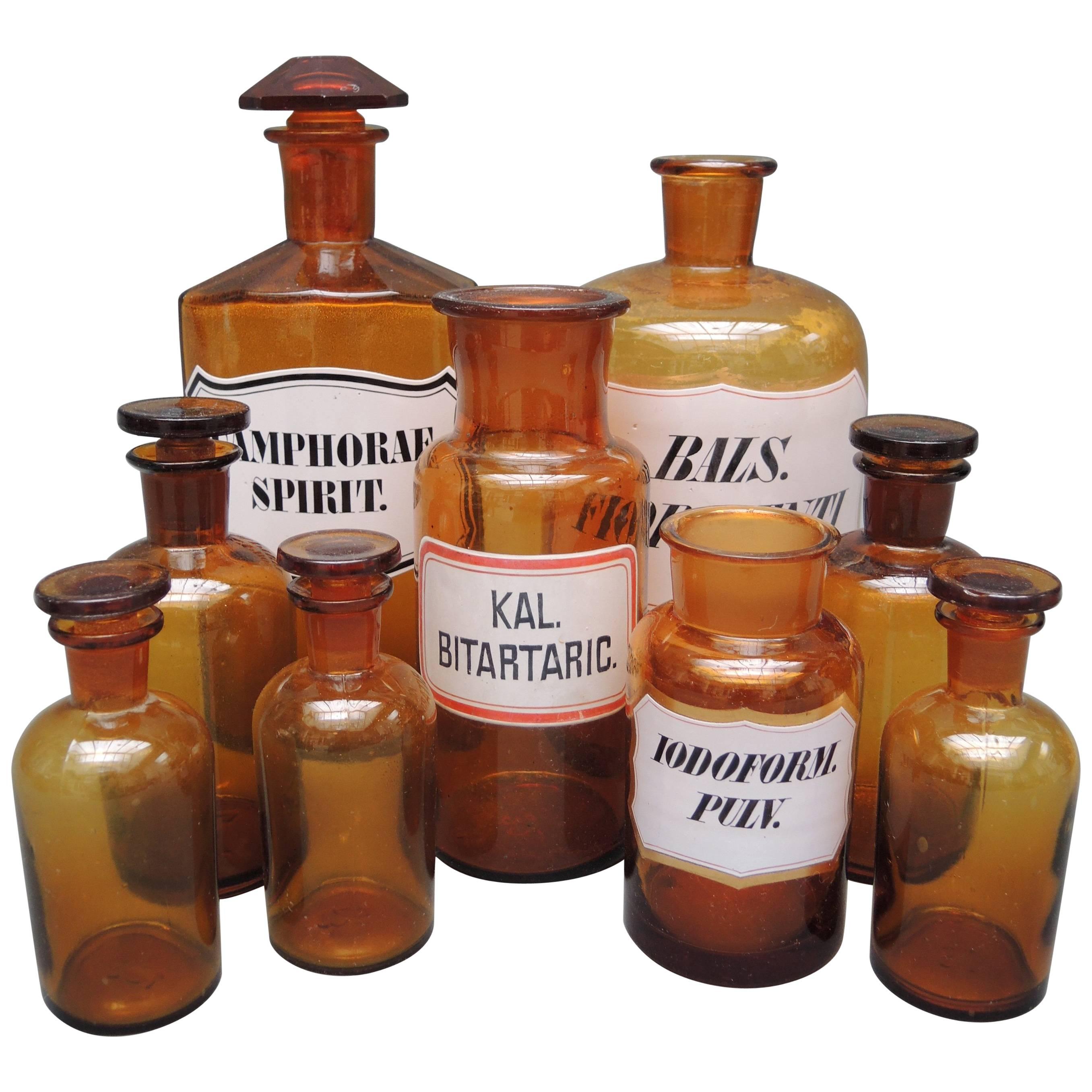 Collection of Nine Belgian Amber Glass Apothecary Bottles, circa 1890 For Sale