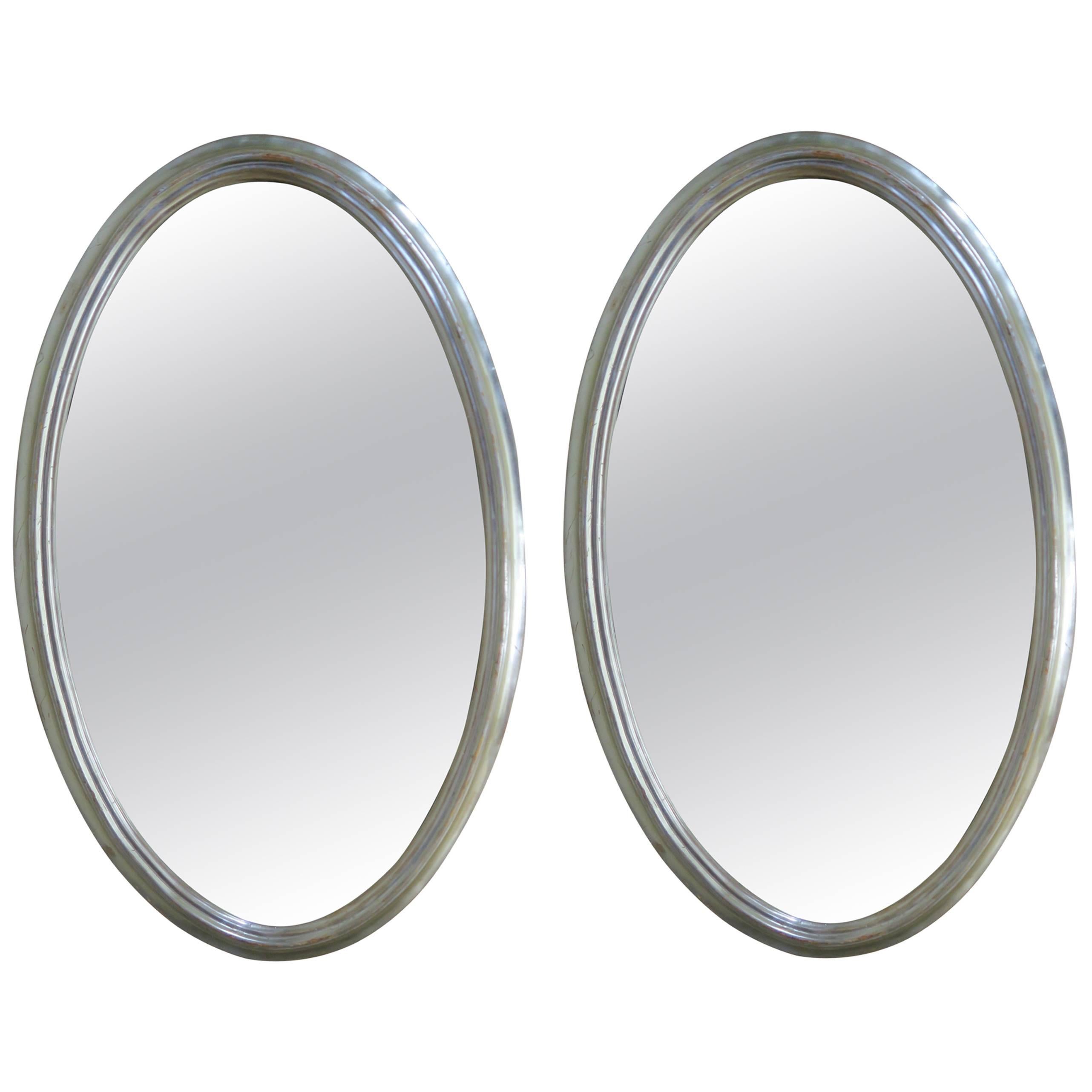 Pair of Mid-Century Oval Silver Mirrors