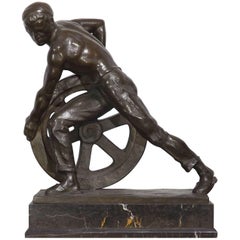 Bronze of a Man Pushing a Wheel by Ernst Seger