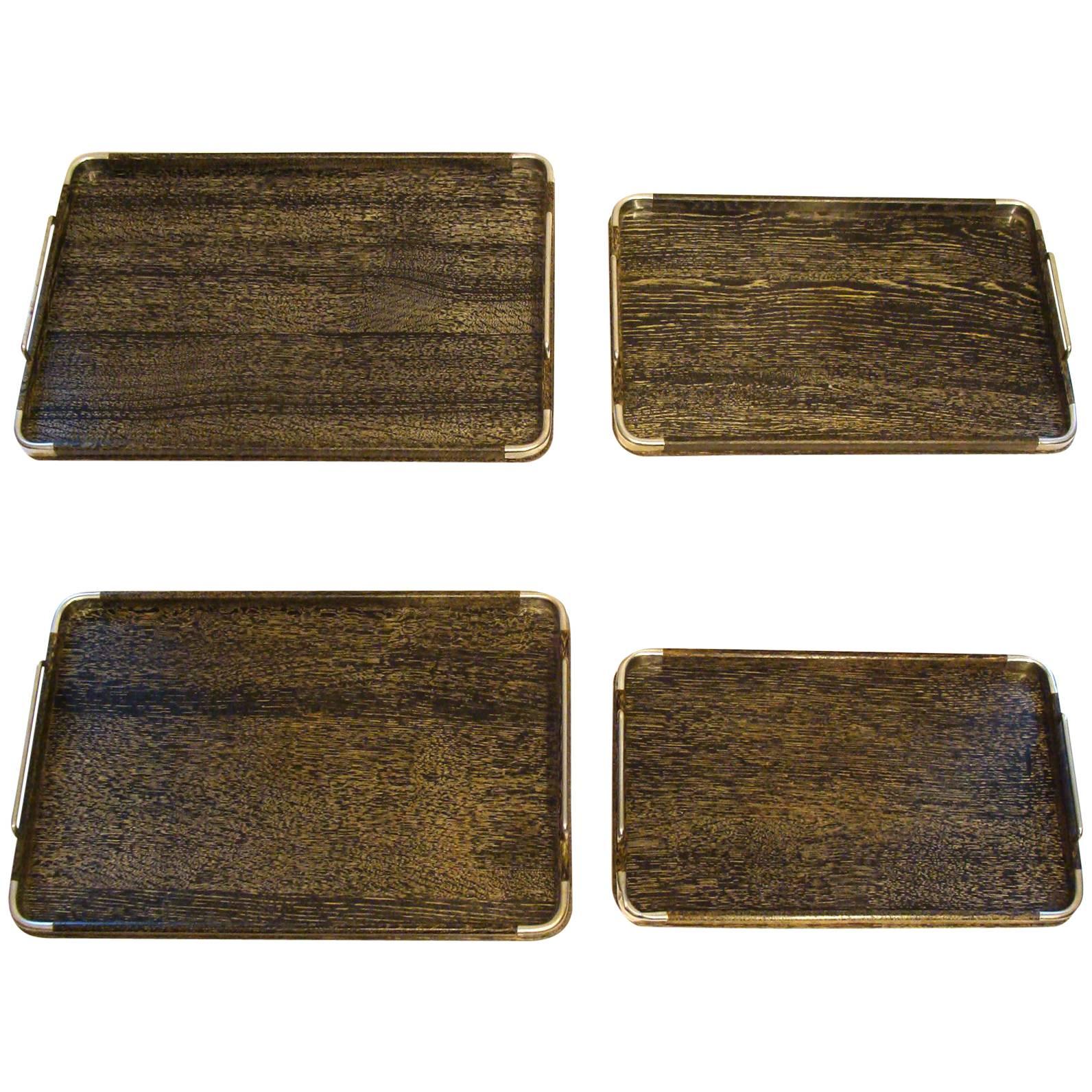 Gorgeous set of four trays, circa 1950-1955 in ebonized/cerused oak with chrome handles and trim. A complete set in great original condition showing very light wear and no corrosion. {These are far superior to the more common trays with bleached