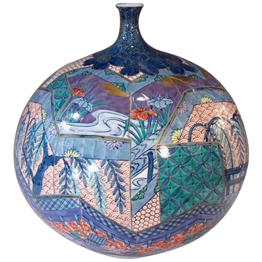 Exquisite contemporary decorative Porcelain vase, intricately hand-painted  with palette of colors showcasing hues of red, blue and green on a striking ovoid body. This is a signed work by highly acclaimed master porcelain artist of the Imari-Arita