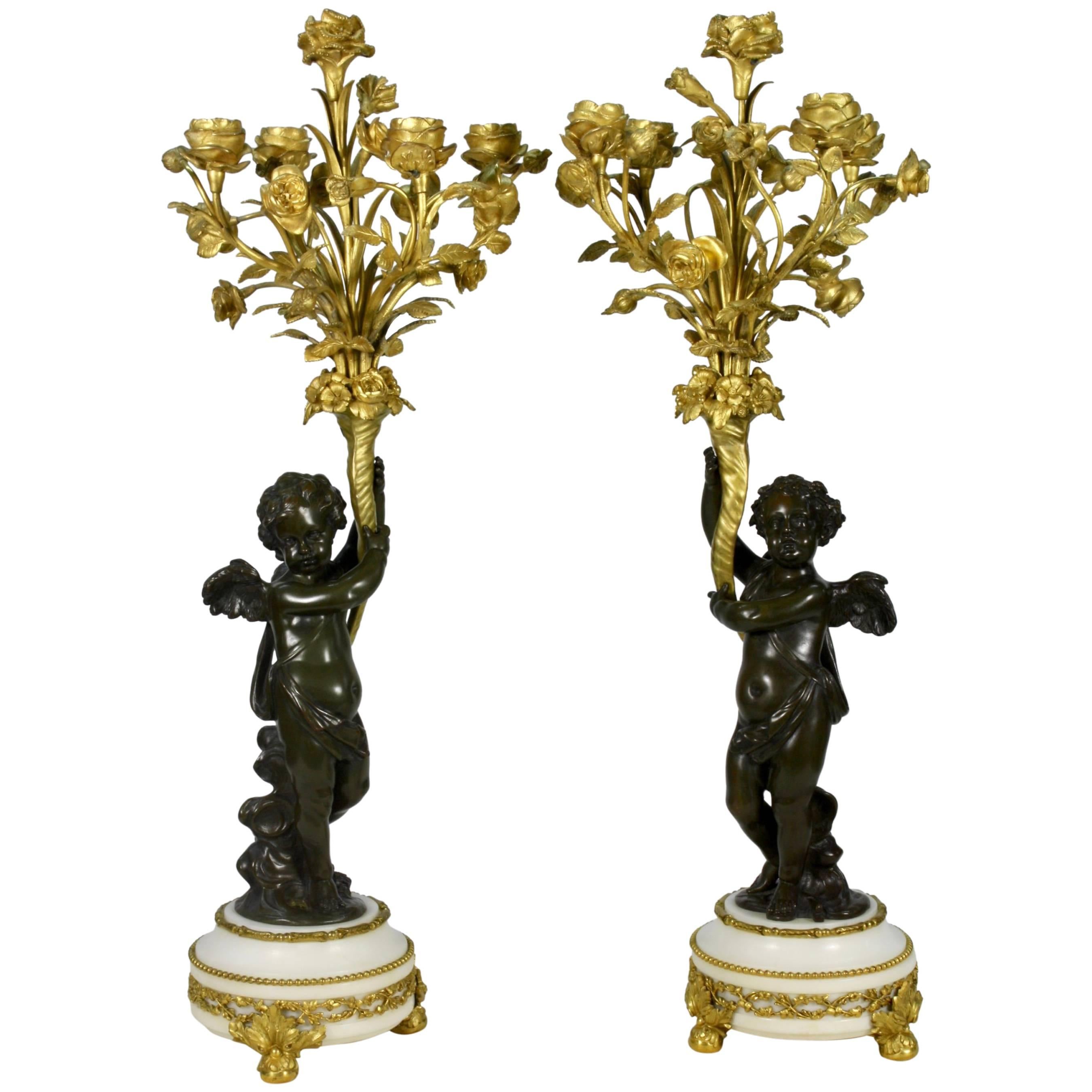 Pair of Gilt and Patinated Bronze Candelabra with Putti Holding Floral Bouquets
