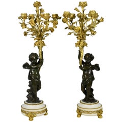 Pair of Gilt and Patinated Bronze Candelabra with Putti Holding Floral Bouquets