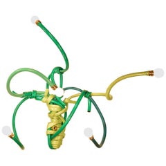 Sconce Style Lighting Fixture Made from Garden Hoses of Varying Shades of Green