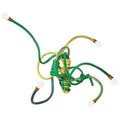 Sconce Style Lighting Fixture Made from Garden Hoses of Varying Shades of Green 