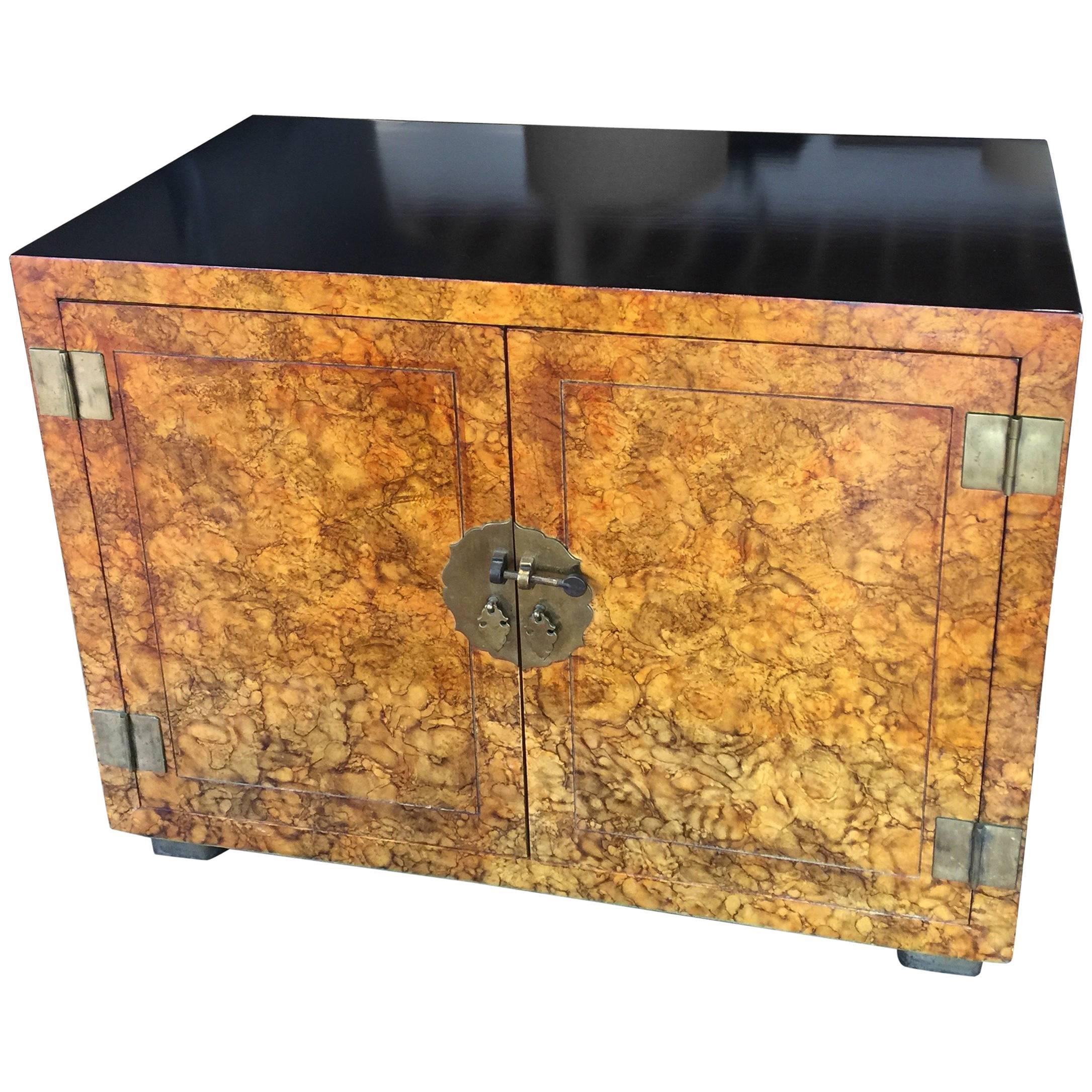 Beautiful two tone chest or cabinet by Henredon made with a gorgeous faux tortoise shell    finish. Detailed with brass hardware that has a perfect patina.  The two cabinet doors open to reveal a single drawer with a shelf below. 