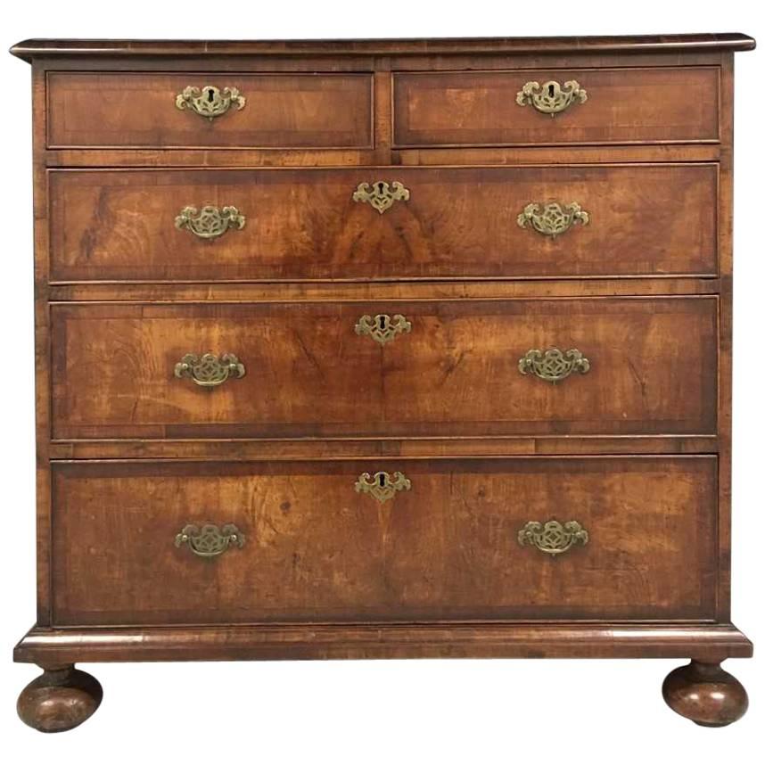 Late 19th century English chest of drawers on bun feet in the William and Mary taste.
