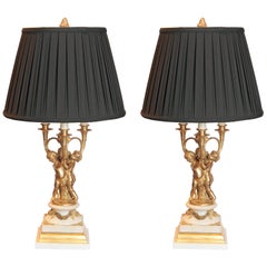 Paire de lampes chérubins françaises du 19ème siècle en bronze doré et marbre à base de marbre