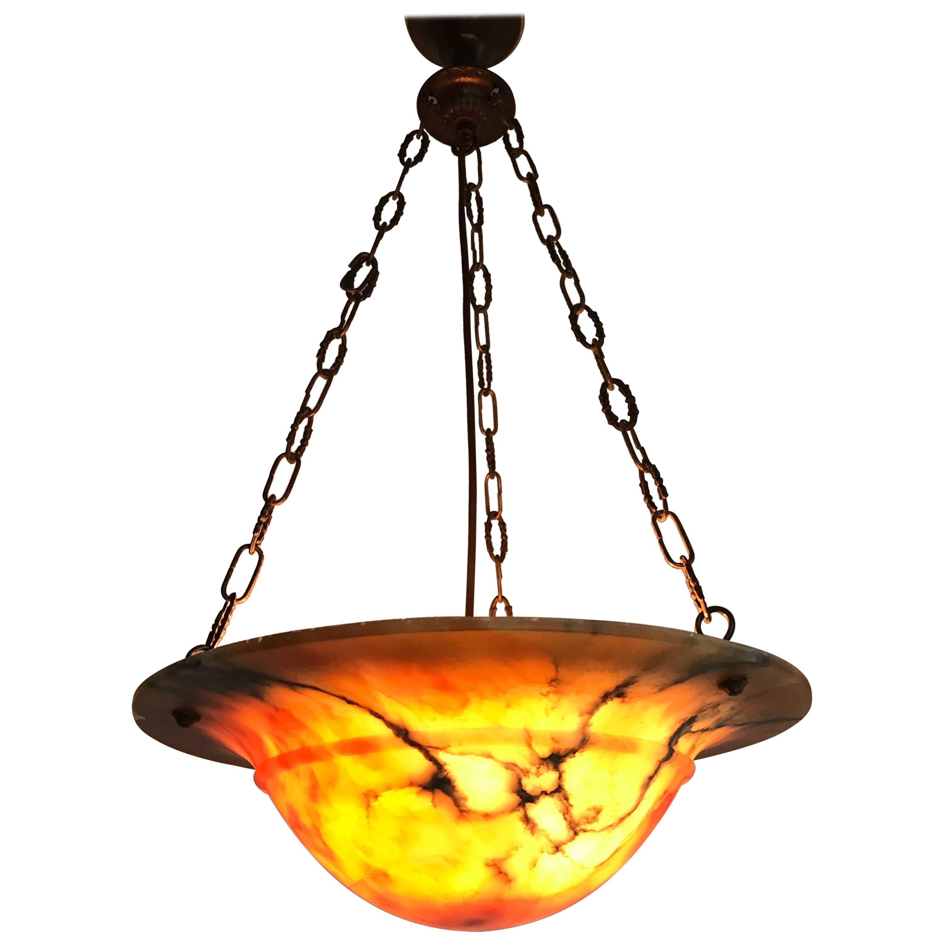 Great shape and color alabaster pendant. 

If you are looking for a good quality and condition pendant then this striking example could be the one or you. This practical size alabaster shade comes with a metal chain and the combination of the two is