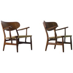 Hans Wegner for Carl Hansen, Denmark, Pair of CH22 Armchairs, 1950s