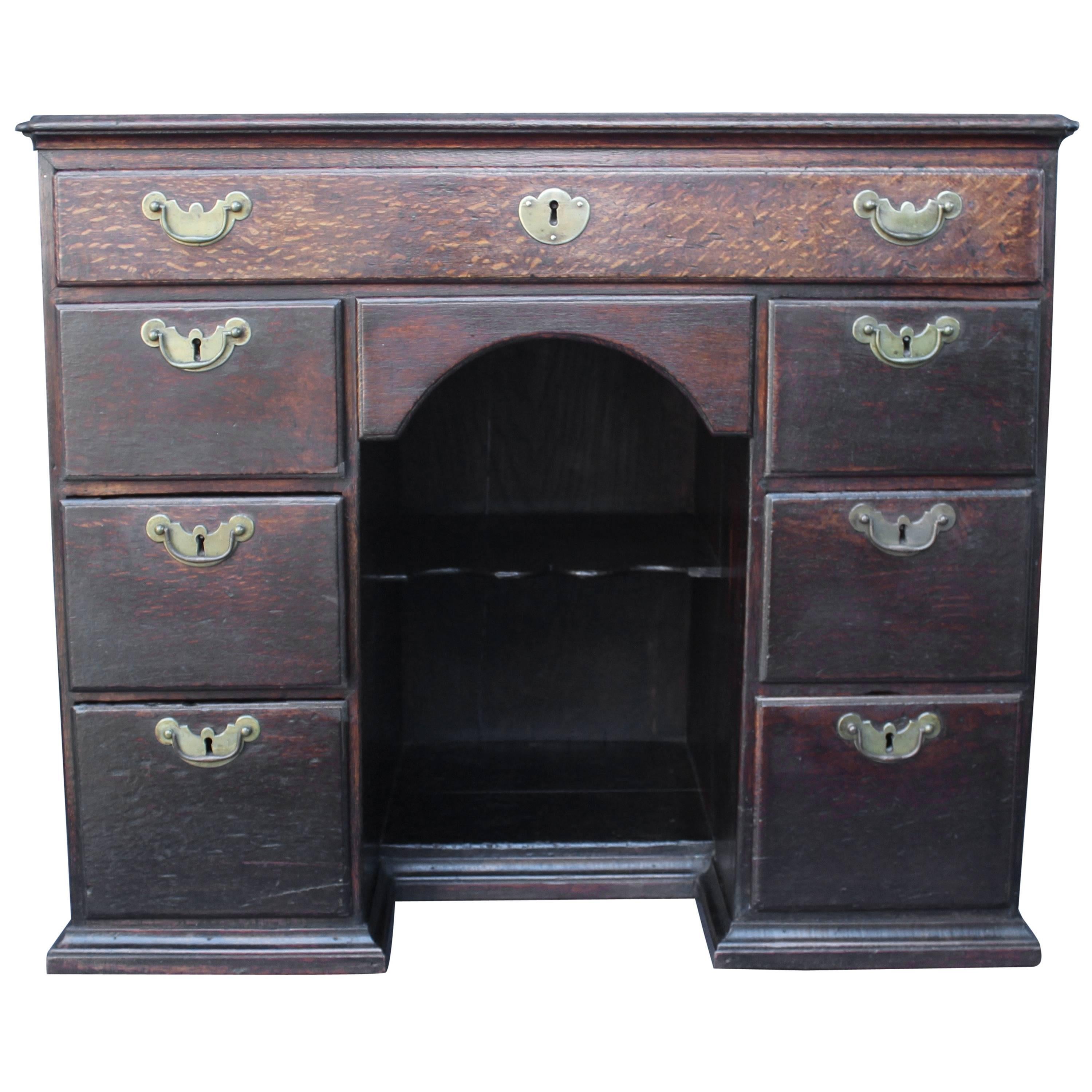 18th century English knee hole desk having seven well working drawers with brass hardware.
Base is not original but well executed to match the overall piece.
 