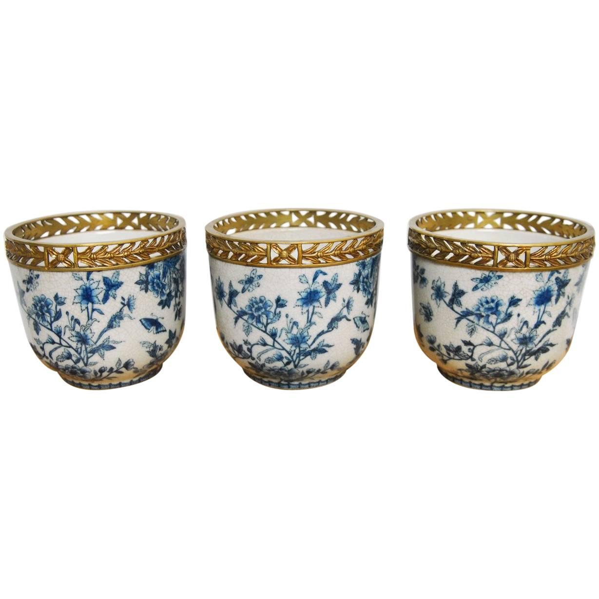 Set of Three Chinese Brass Mounted Blue and White Porcelain Urns