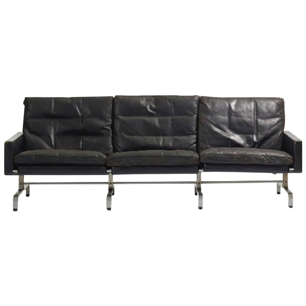 Poul Kjærholm PK 31/3 sofa, black leather, matte chrome-plated steel. Signed with impressed manufacturer's mark to underside.