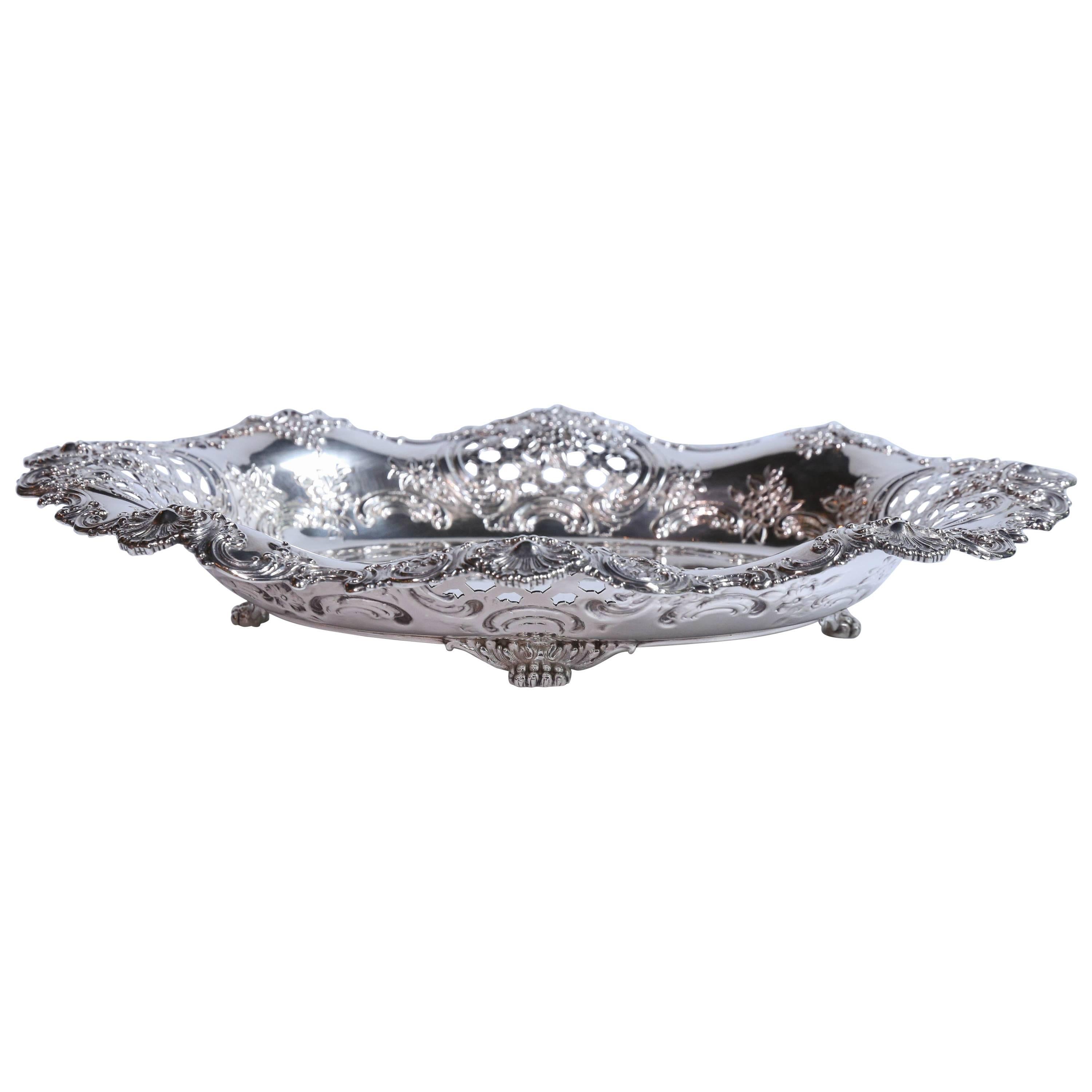 Very fine sterling tray with oval shape having tapering and lobed sides.
Reticulated open work on all four sides. Floral and foliage designs embellish
This lovely bowl. It rests on beaded feet.