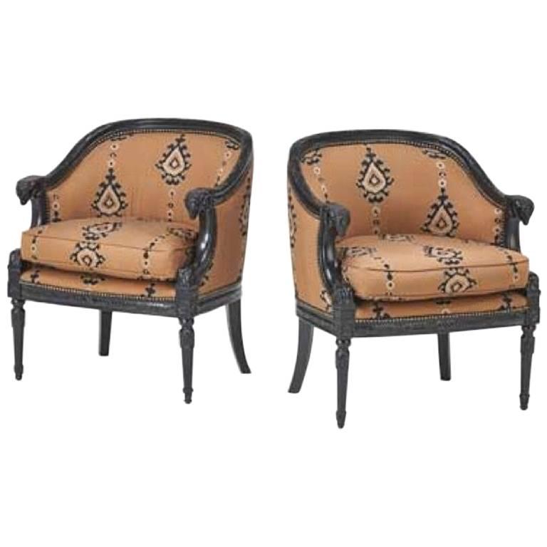Pair of Bergere chairs with carved ram head arms