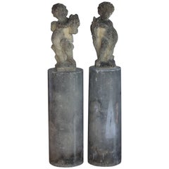 Pair of English Vintage Garden Putti on Tall Columns