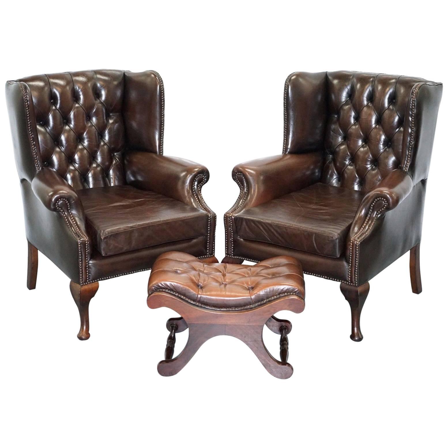 Pair of 1960s Aged Brown Leather Chesterfield Wingback Armchairs and Footstool