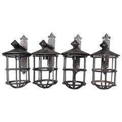Four French Iron Fleur-de-Lis Carriage House Sconces with Caged Bulb Covers