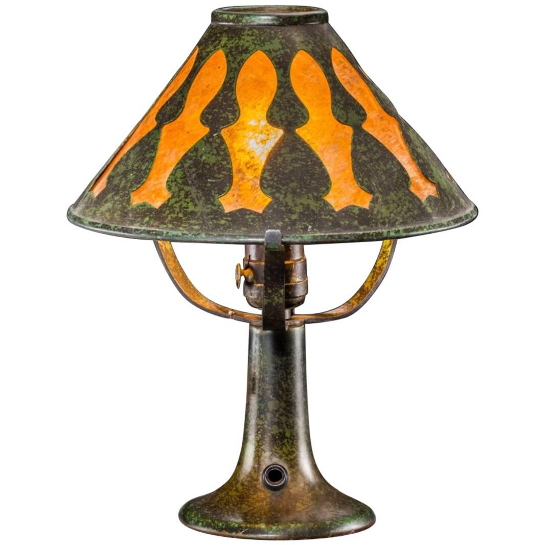A Heintz patinated bronze and silver overlay table lamp, circa 1920 Art Nouveau, Art Deco, Arts & Crafts design. Shade is made of bronze and mica; a heat resistant, translucent natural stone. Perfect as a desk or bedside table lamp emitting a