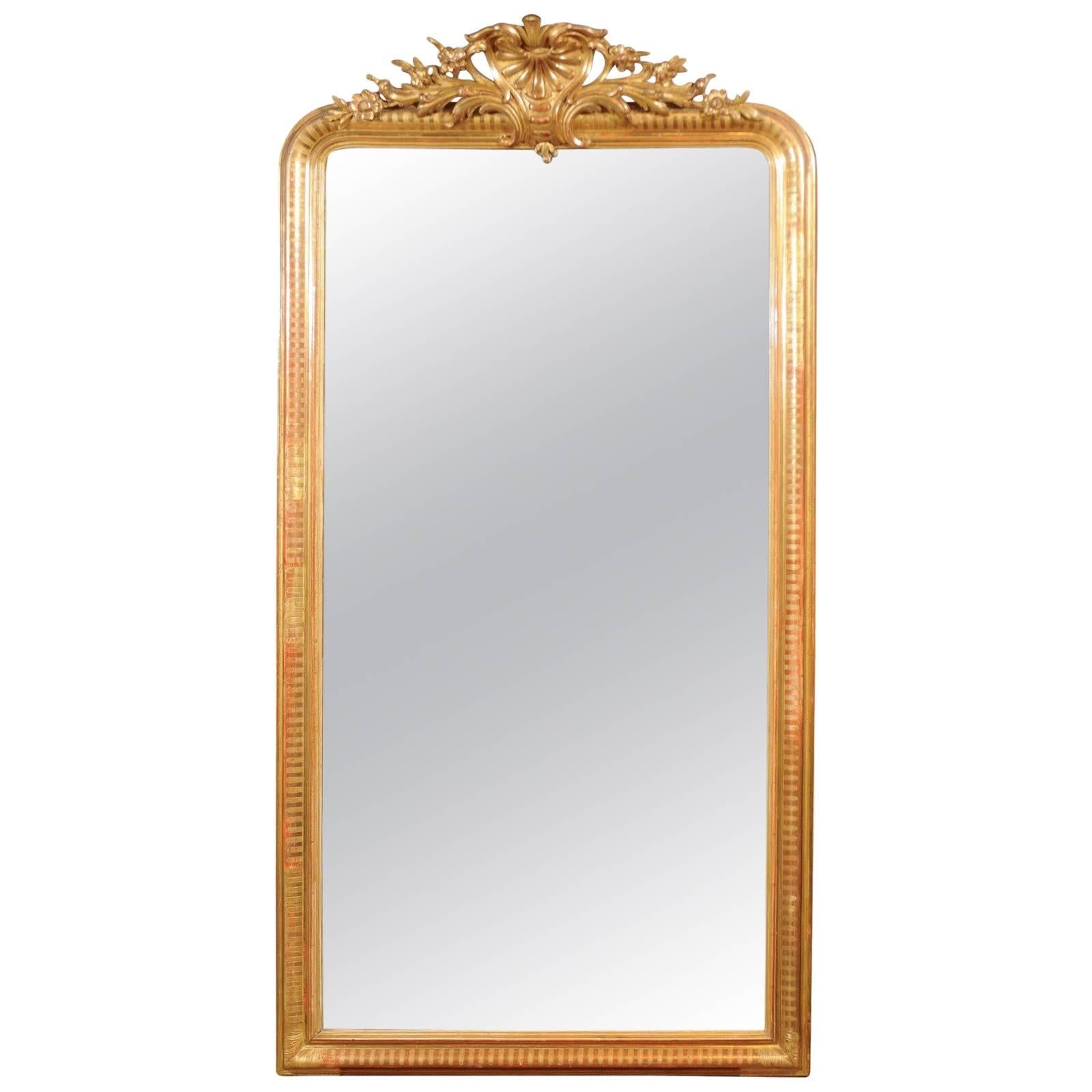 French Rococo Style Tall Giltwood Mirror with Carved Crest from the 1880s