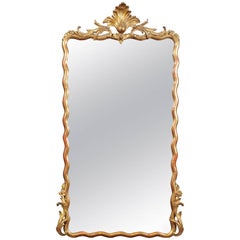 French Louis XV Style Giltwood Mirror with Sinuous Frame and Carved Crest, 1880s