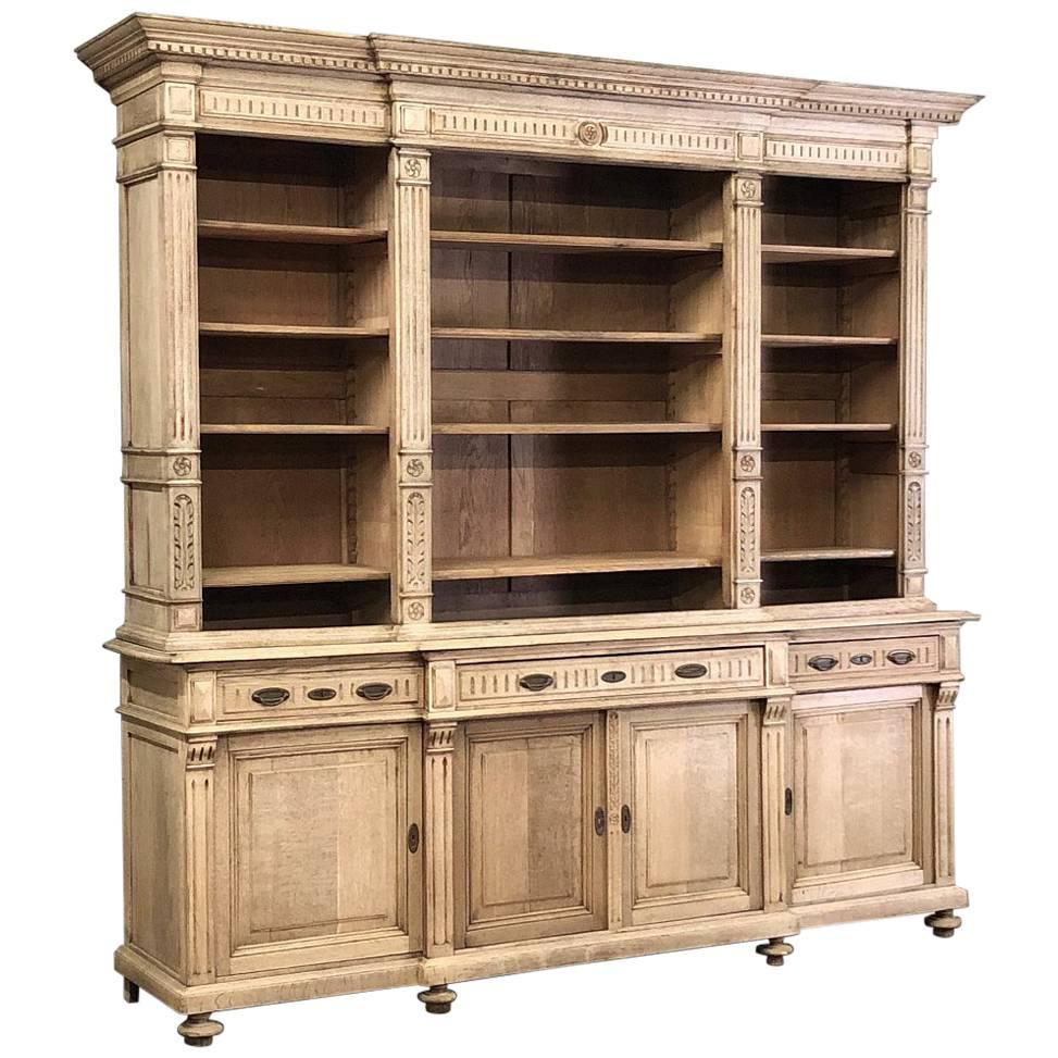 19th century stripped oak neoclassical bookcase is an amazing focal statement furniture for any room! Handcrafted from solid oak with an abundance of shelves combined with classic architectural detail, it features fluted pilasters, dentil molding,