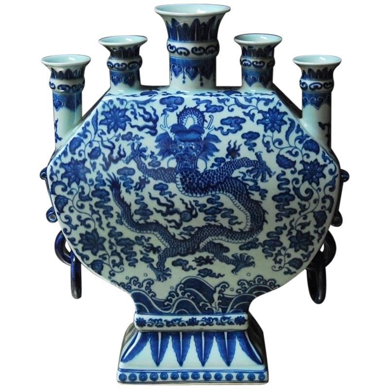 Fascinating Chinese blue and white porcelain five mouth dragon bud vase or tulipiere. Featuring a large moon flask shaped body with rings attached to the sides. The vase is topped with four small tulip mouths and centered by a large mouth. A five