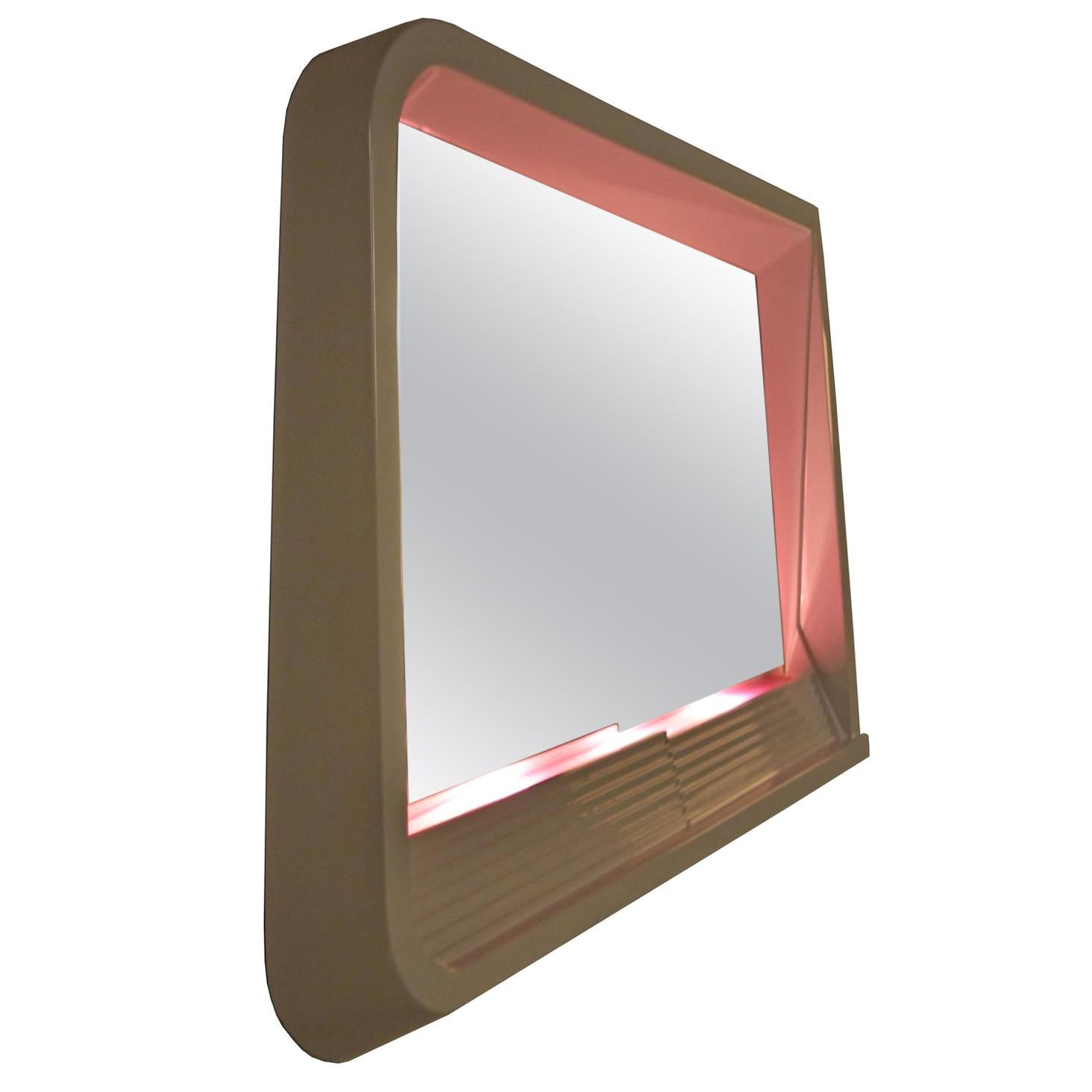 It simply doesn't get any cooler than this epic Postmodern Art Deco revival Futurist lighted wall mirror. Allow the magical illumination to enhance the ambiance of your space and set the tone with its soft magenta hue. Bask in the sexy glow with