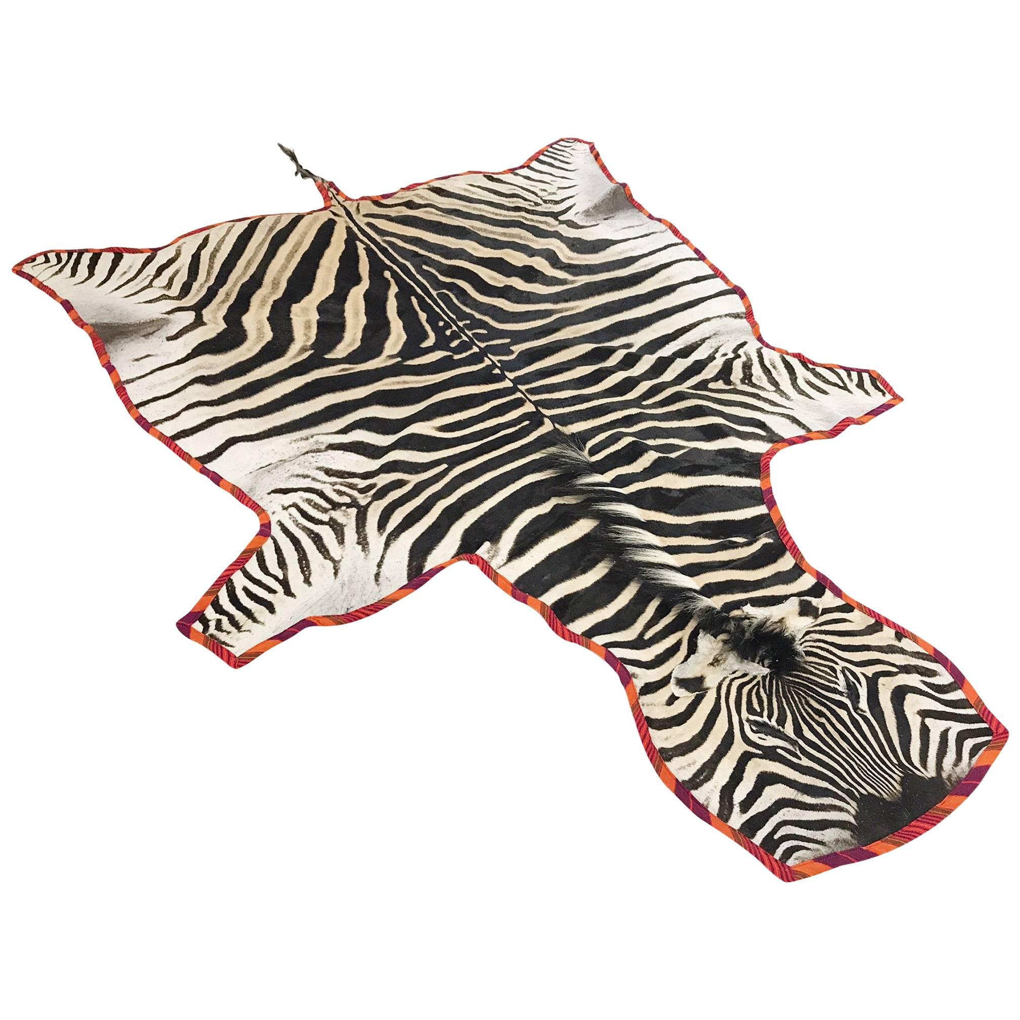 Zebra Hide Rug Trimmed in Maasai Warrior Blanket