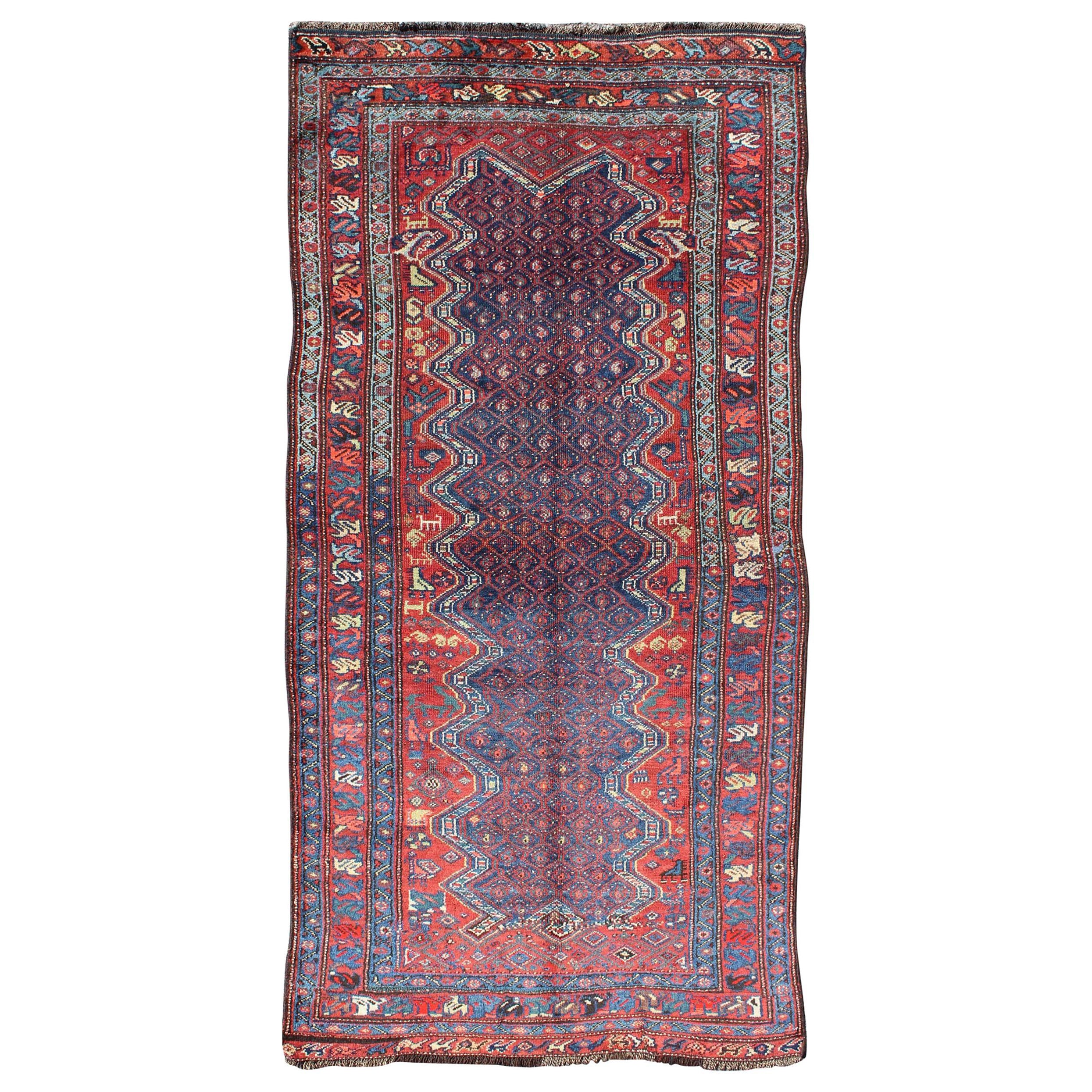 Blue Background Antique N.W. Persian Rug with Zig-Zag Field and Tribal Motifs For Sale