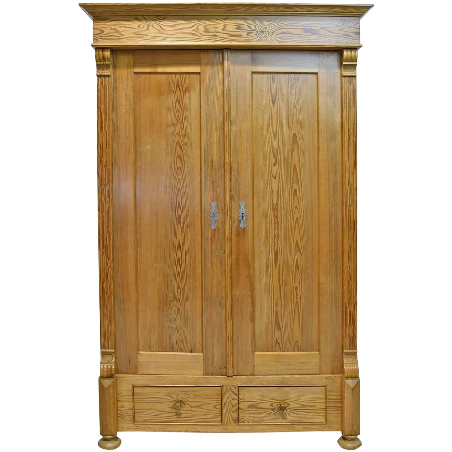 19th Century European Two-Door Pine Armoire with Drawers and Retractable Doors