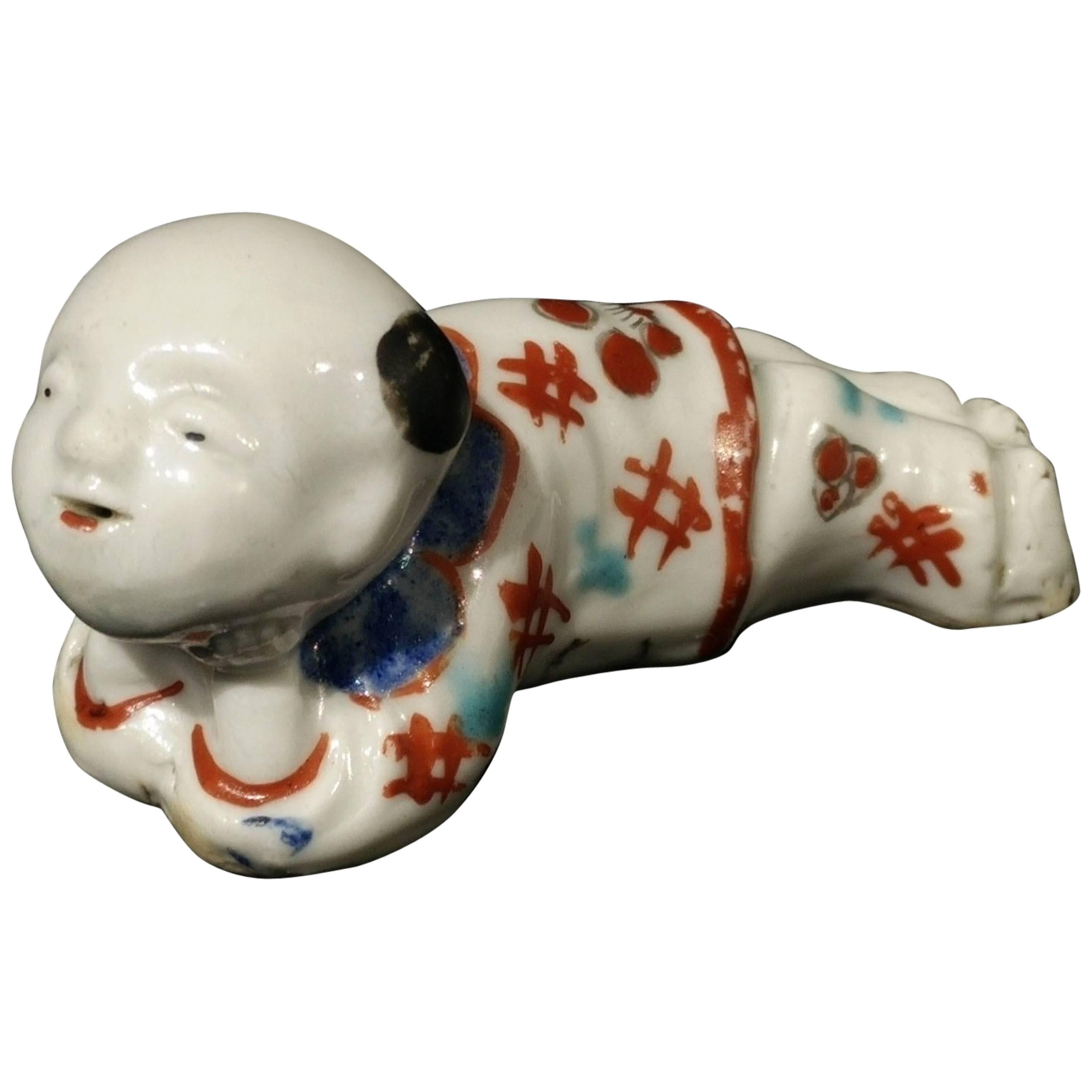 17th Century Japanese Early Kakiemon Porcelain Small Boy Shaped Whistle For Sale
