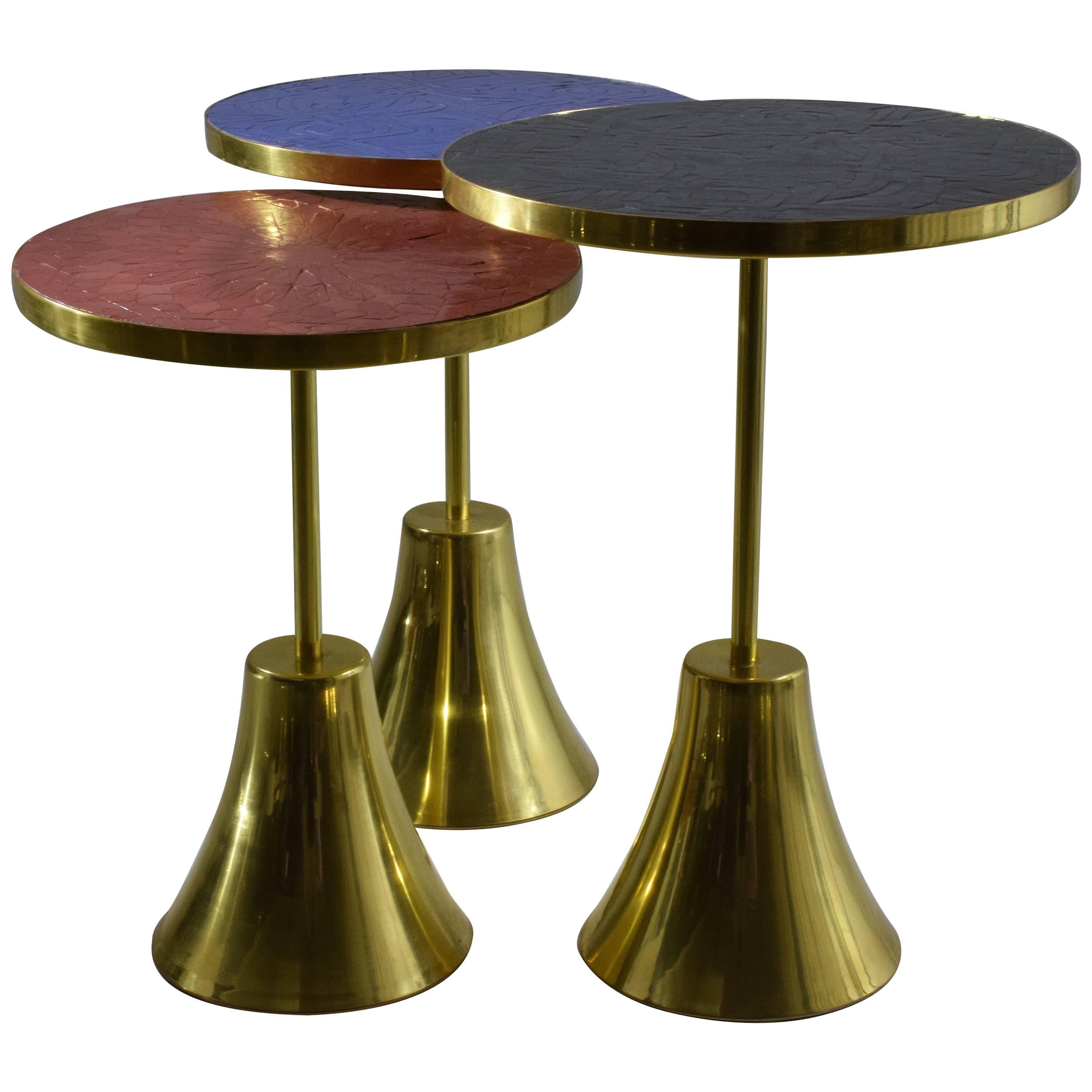 Set of three contemporary handcrafted guéridon side or end nesting tables composed of a solid brass structure and designed with two intricate mosaic tile tabletop zellige designs handmade with expert workmanship by Moroccan artisans. This set of