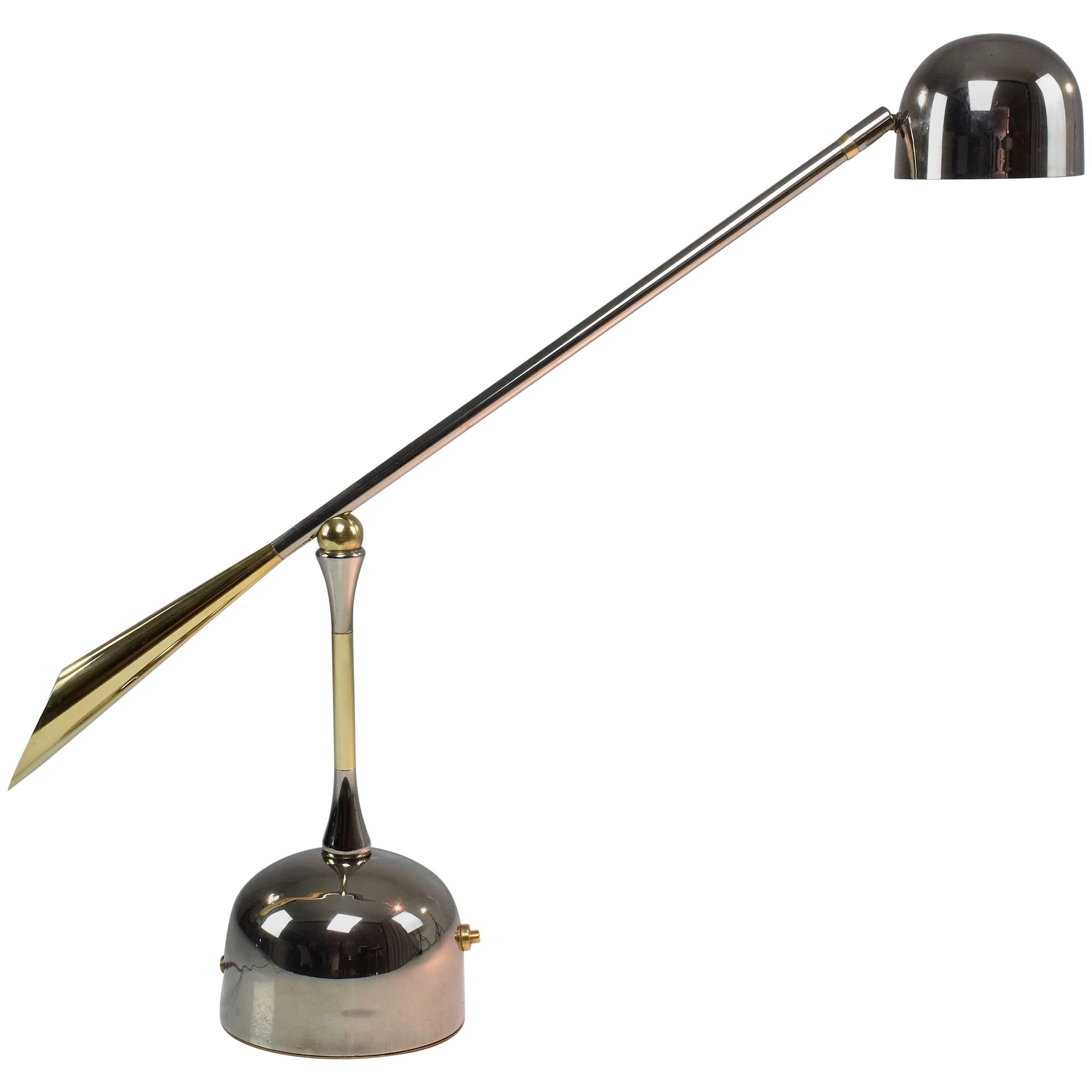 Contemporary handcrafted articulating desk or accent lamp composed of a solid nickel plated brass structure and designed with polished brass finishes and a unique rotatable pear-shaped joint. This piece rotates around three axis: the shade, the arm,
