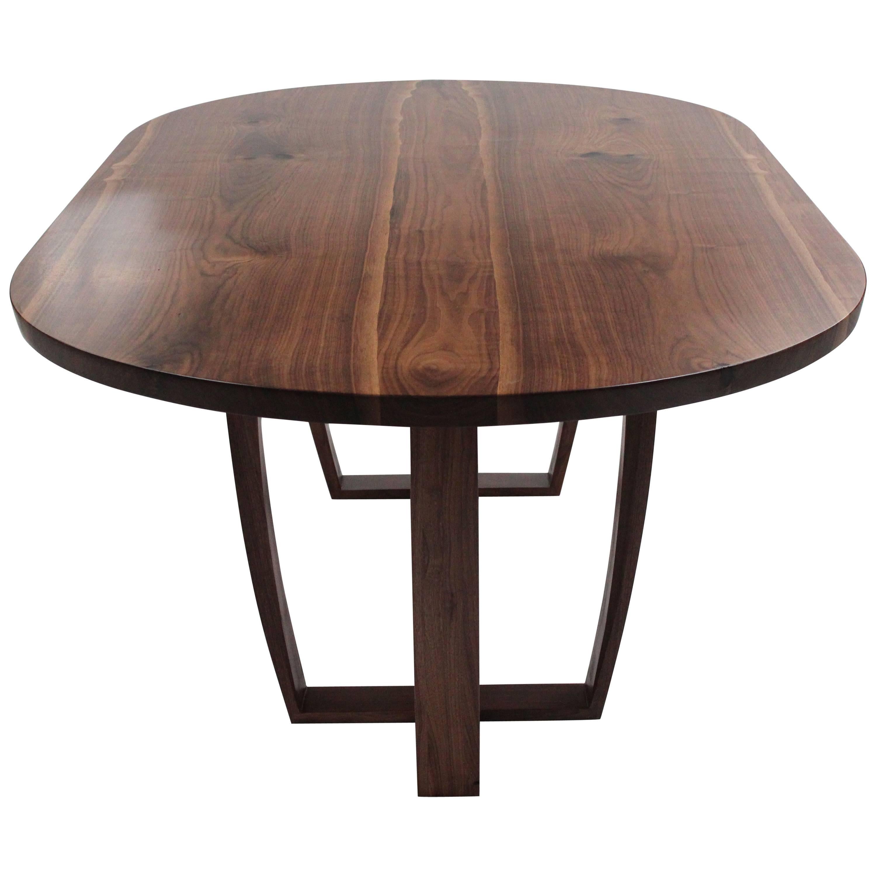 Contemporary oval dining table in book matched American black walnut. Bespoke. 