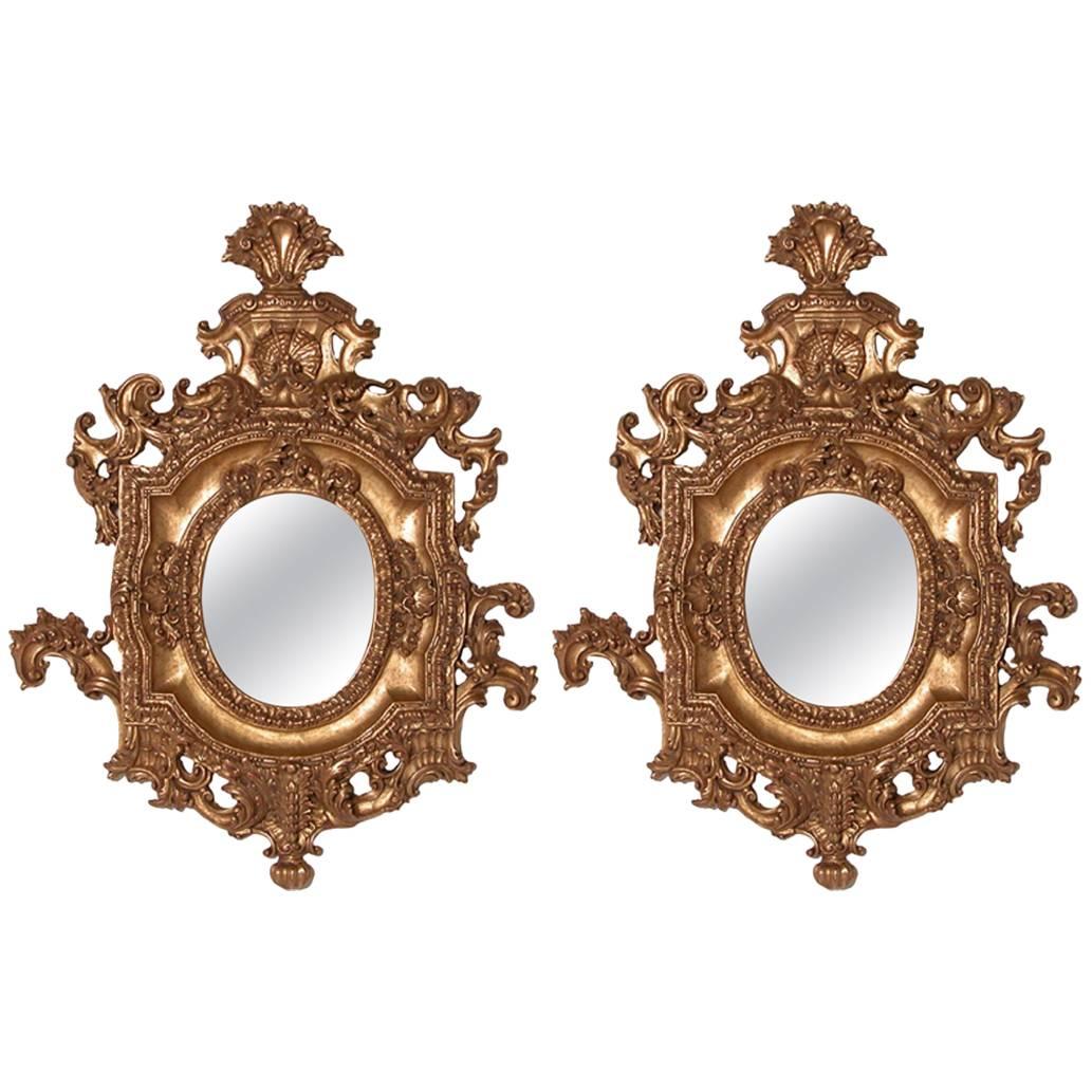 Pair of Ornate Oval Mirrors Hand-Carved Wood Finished in Aged Gold Leaf For Sale