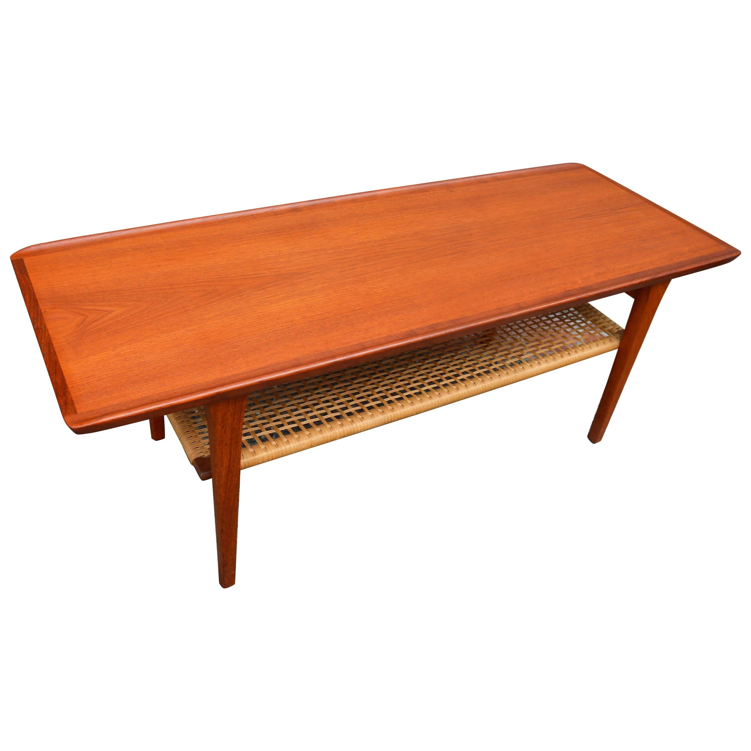 Danish Teak Coffee Table Flared Edges and Lower Cane Shelf by Mobelintarsia