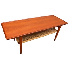 Danish Teak Coffee Table Flared Edges and Lower Cane Shelf by Mobelintarsia