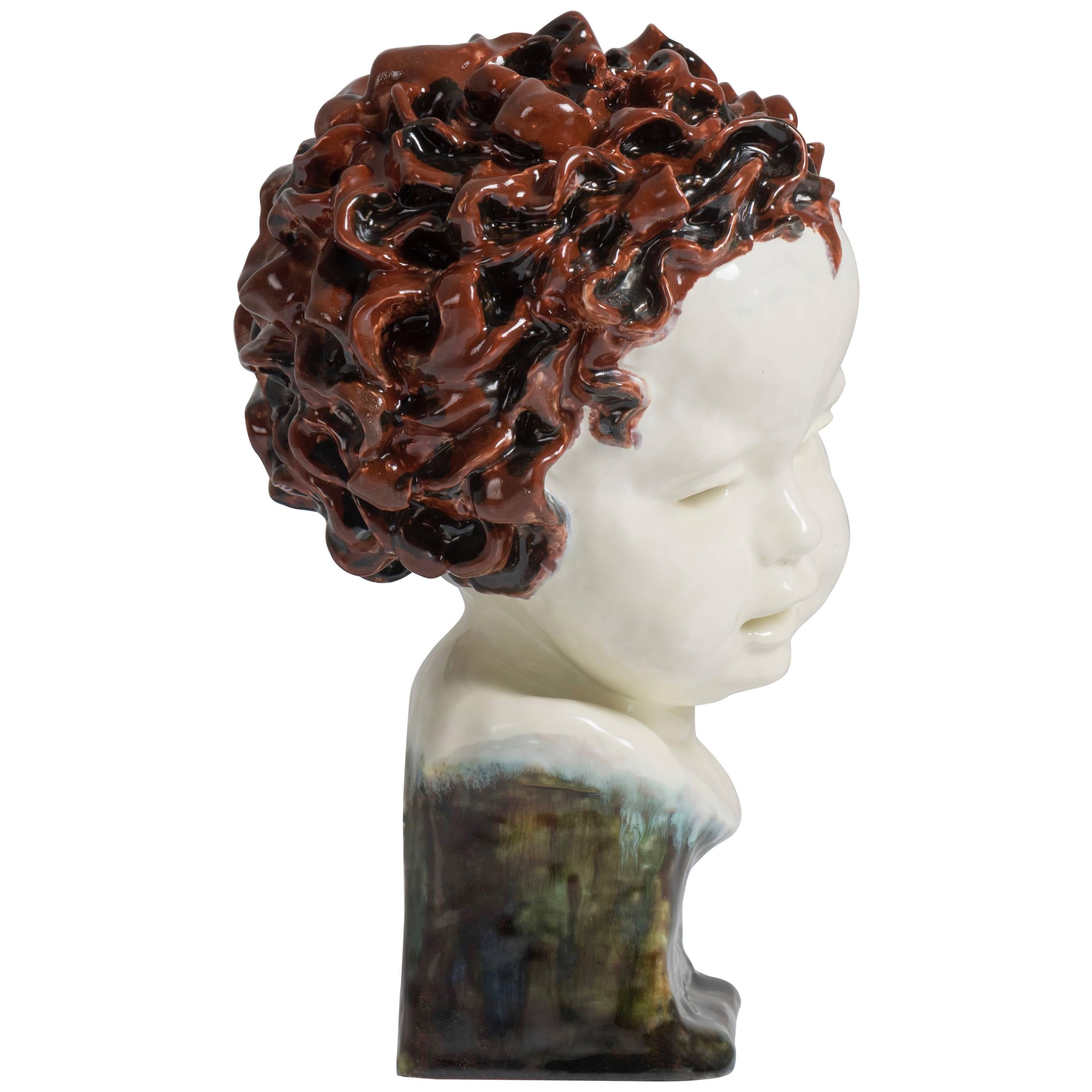 This child head is a unique piece. The colors are very subtle and the curly hair very well sculpted.
Signed and dated on the back and Goldscheider stamps on the inside.

Dimensions: 26 cm height x 17 cm diameter.

In 1885, Friedrich Goldscheider