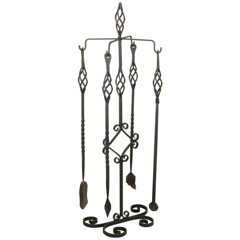 Set of Large Late 19th Century French Wrought Iron Fireplace Tools and Stand For Sale at 1stdibs For Sale on 1stdibs - This artisan-made set of large hand forged iron fireplace tools was originally used at the massive stone fireplace of a French castle in Normandy
