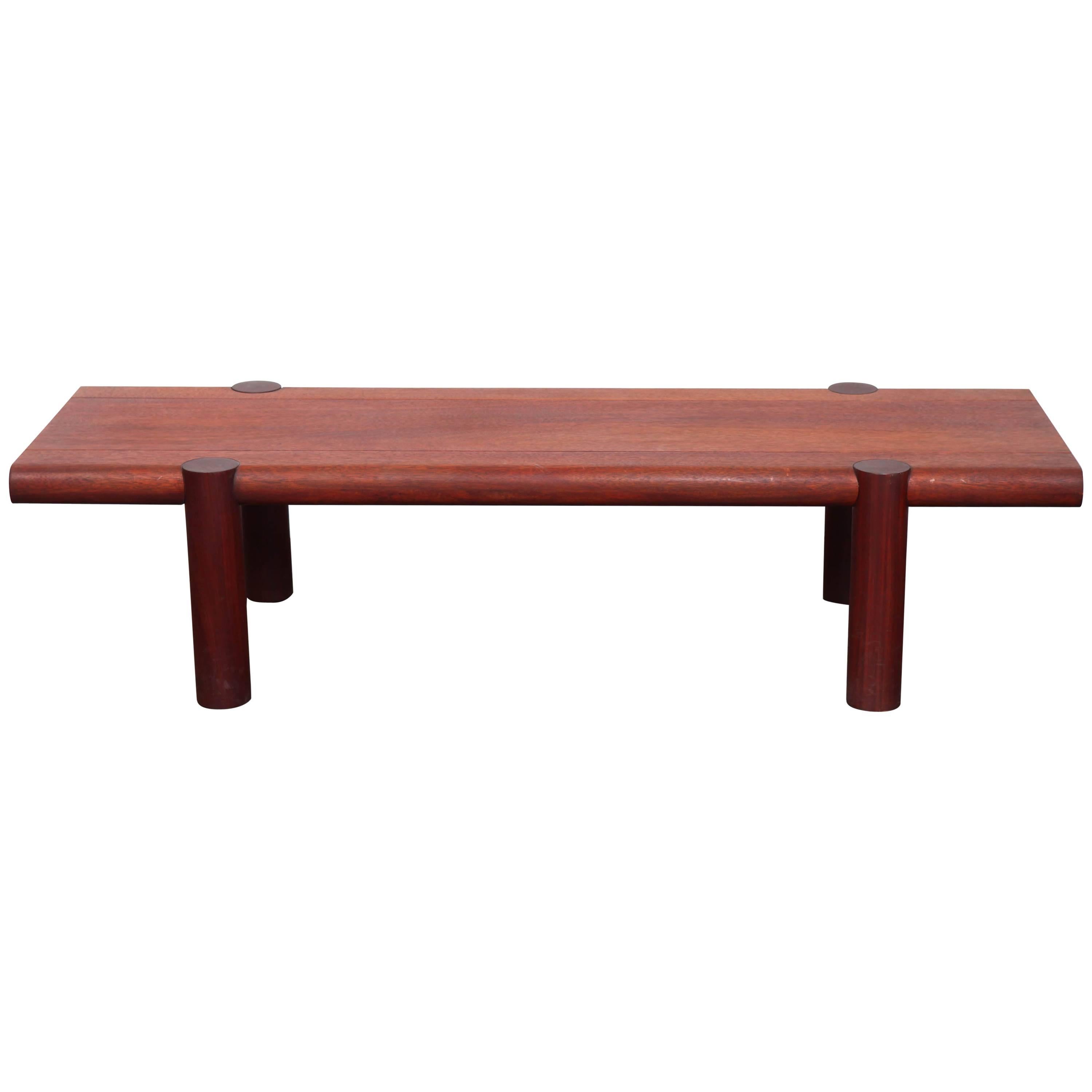 Long mahogany coffee table with cylindrical legs designed by celebrated midcentury Californian designer Sherrill Broudy. Made from solid mahogany with an oil finish, it was purchased from the designer's own home. Sherrill Broudy was one of the