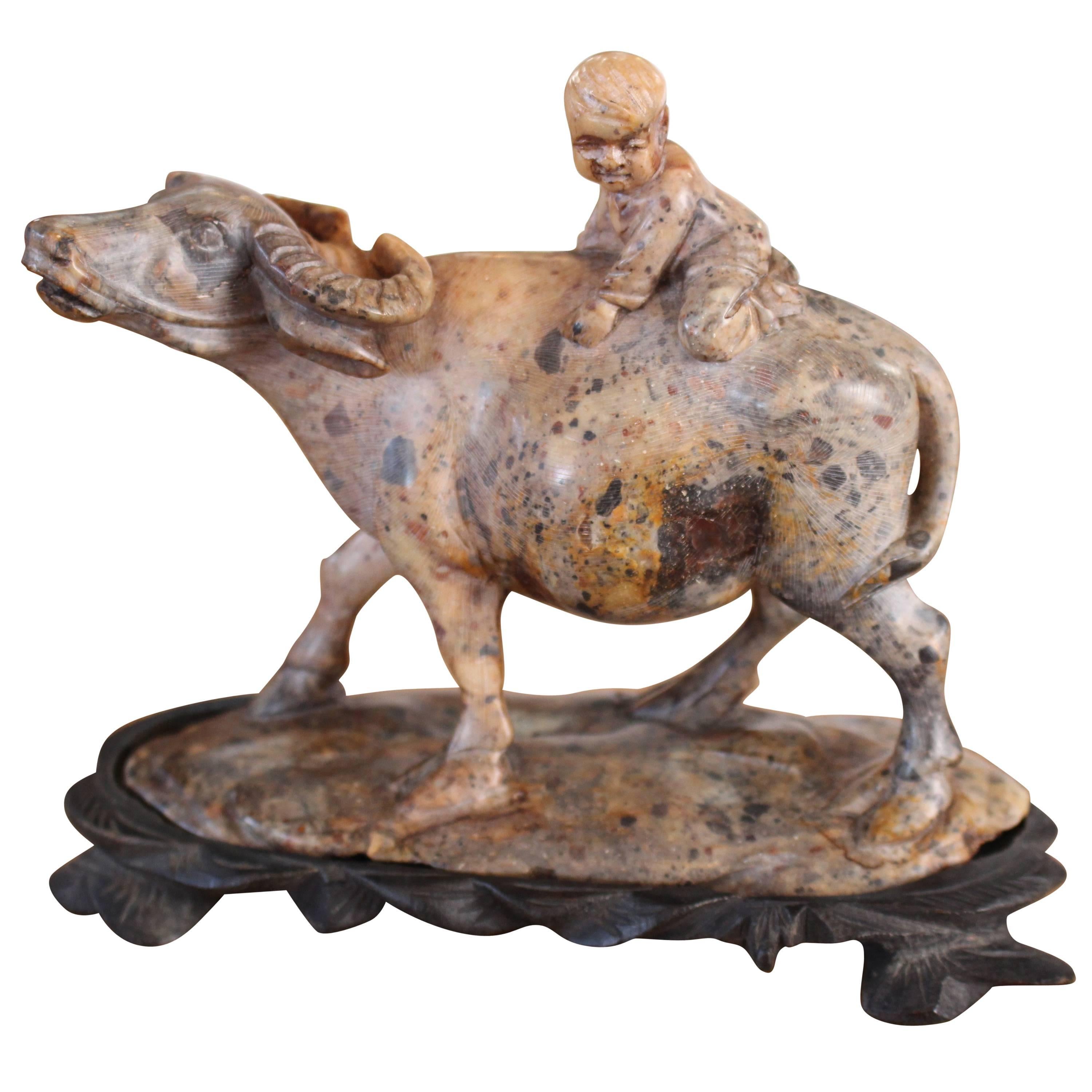 A Chinese Carved Soapstone Sculpture Of A Child On A Water Buffalo