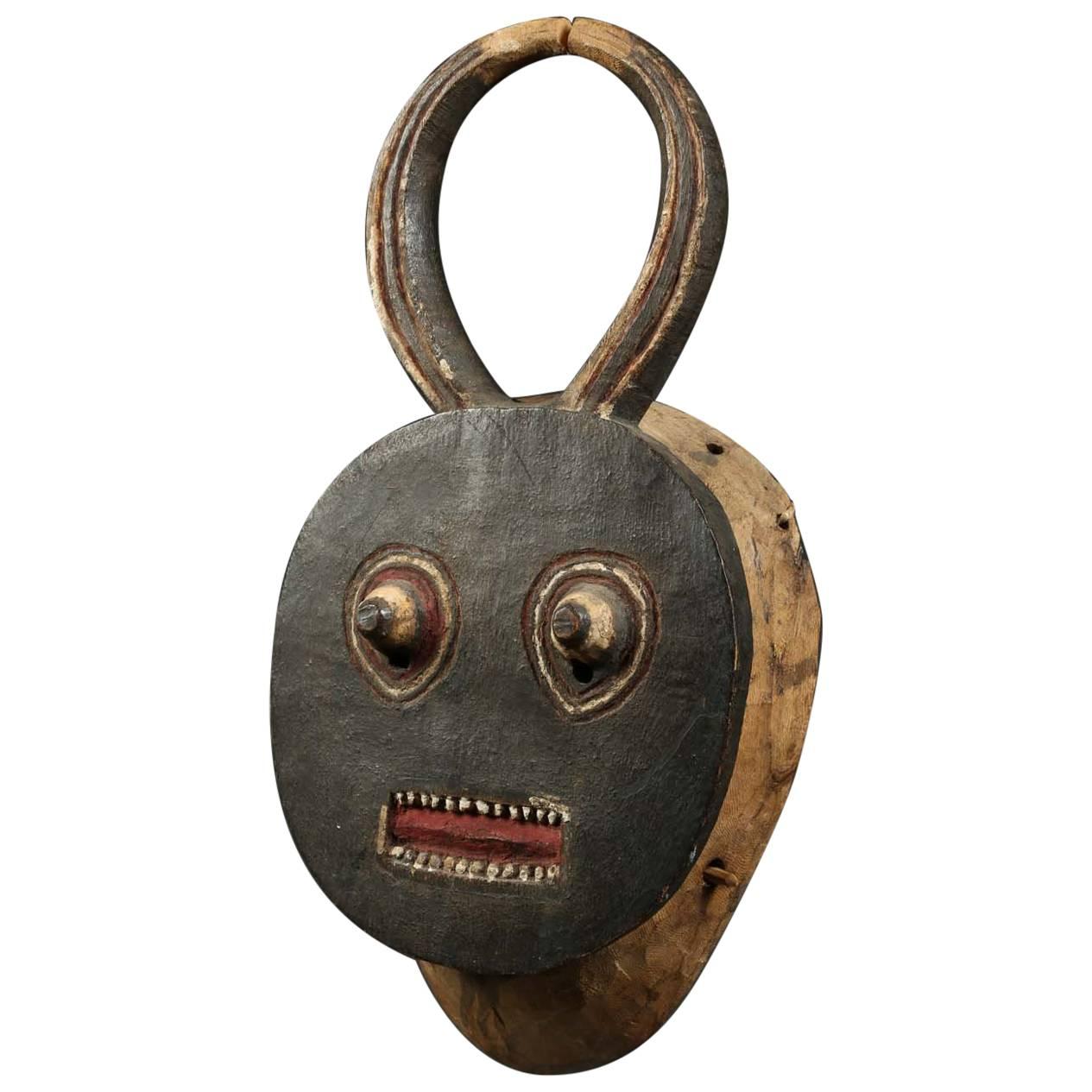 Baule Kple kple tribal mask, ivory coast, Africa, early 20th century, provenance

Striking Baule dance mask, with original bite stick, round face with open mouth with teeth, projecting eyes and oval curved horns rising from the flat face. Black,