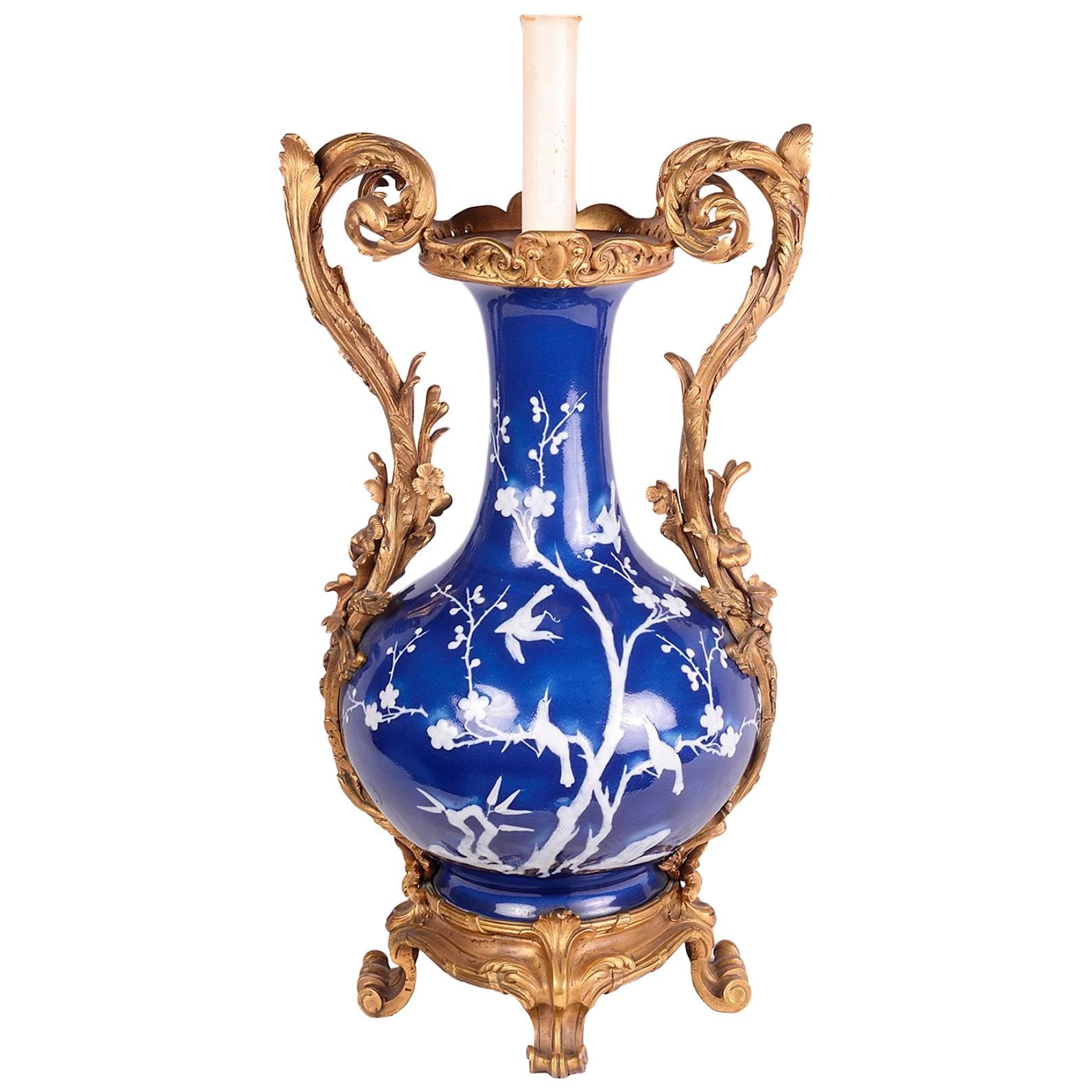 A striking Chinese Blue and White vase, having French scrolling foliate ormolu mounts and handles.
Converted to a lamp.